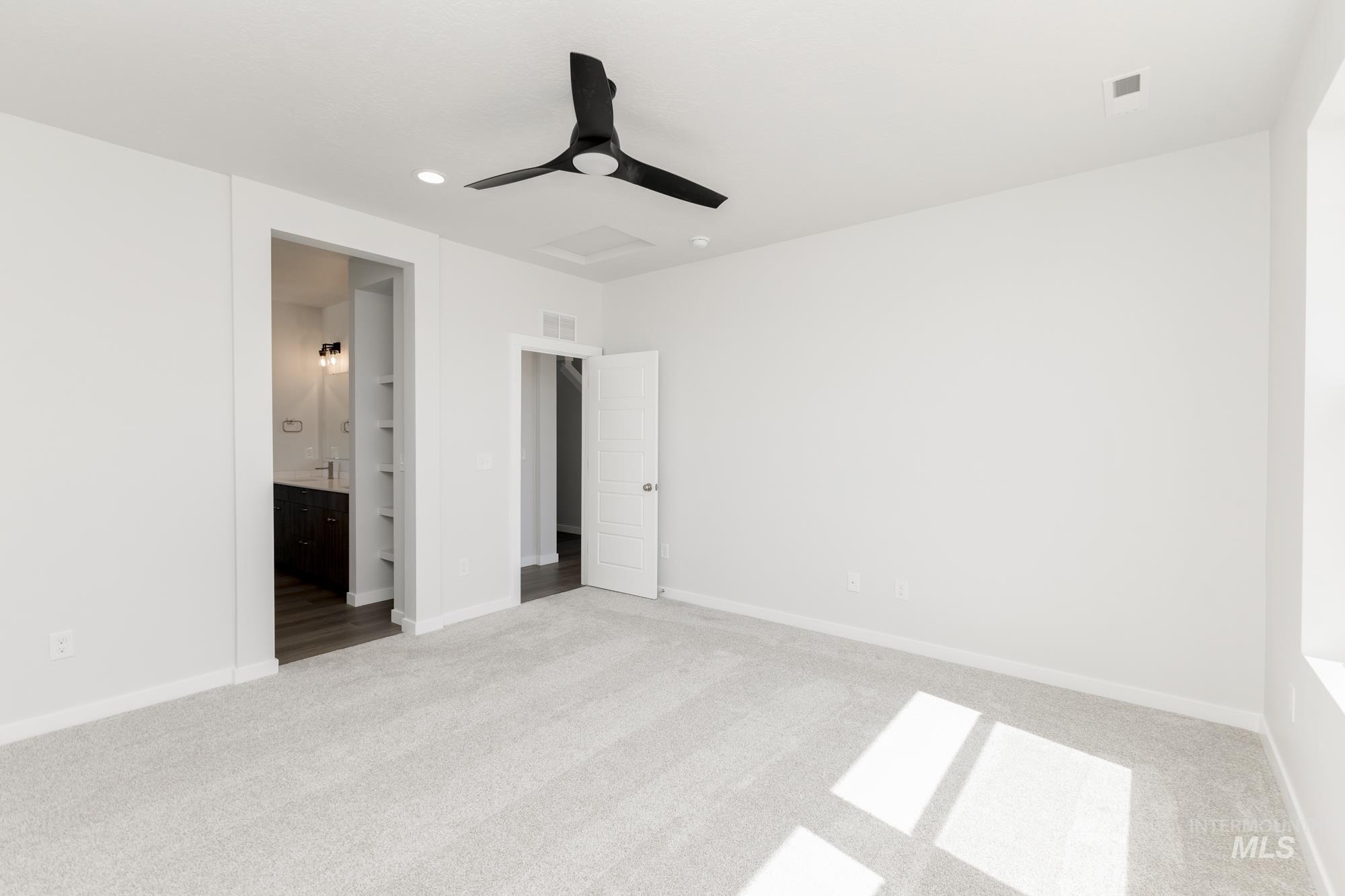 Unfurnished bedroom with carpet, ensuite bathroom, ceiling fan, and recessed lighting