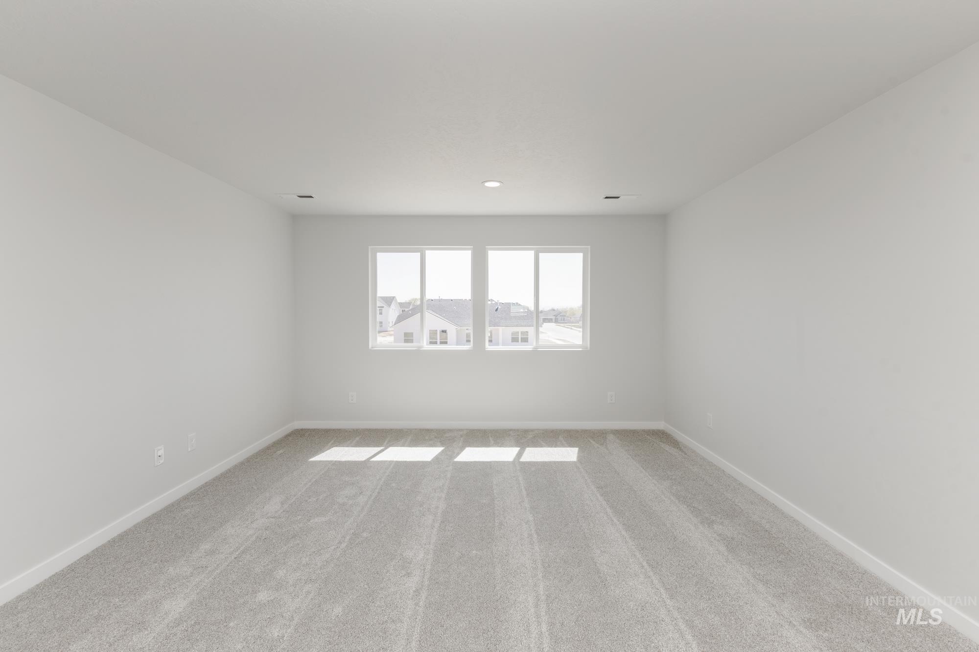 Spare room with carpet floors and baseboards