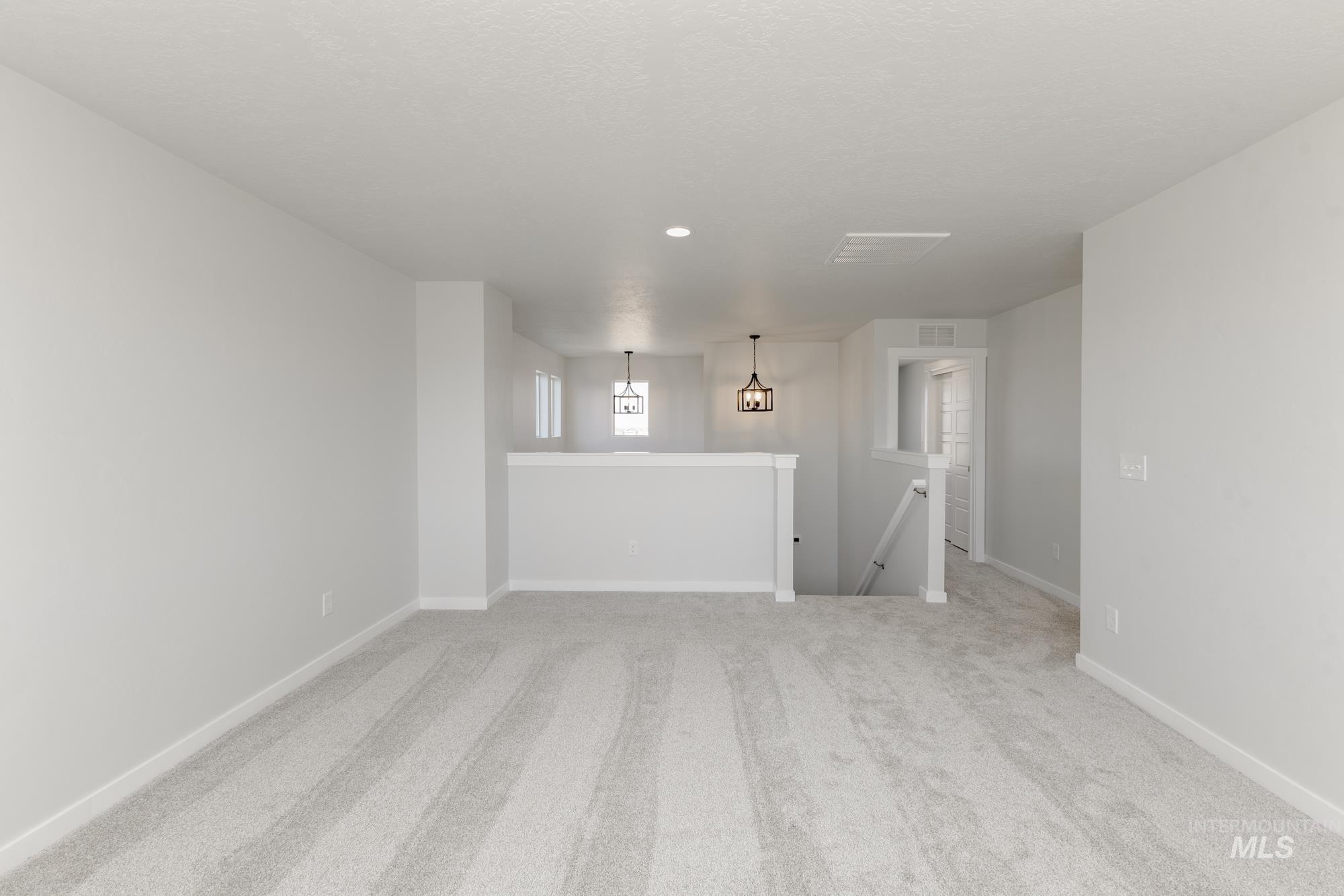 Unfurnished room featuring light carpet