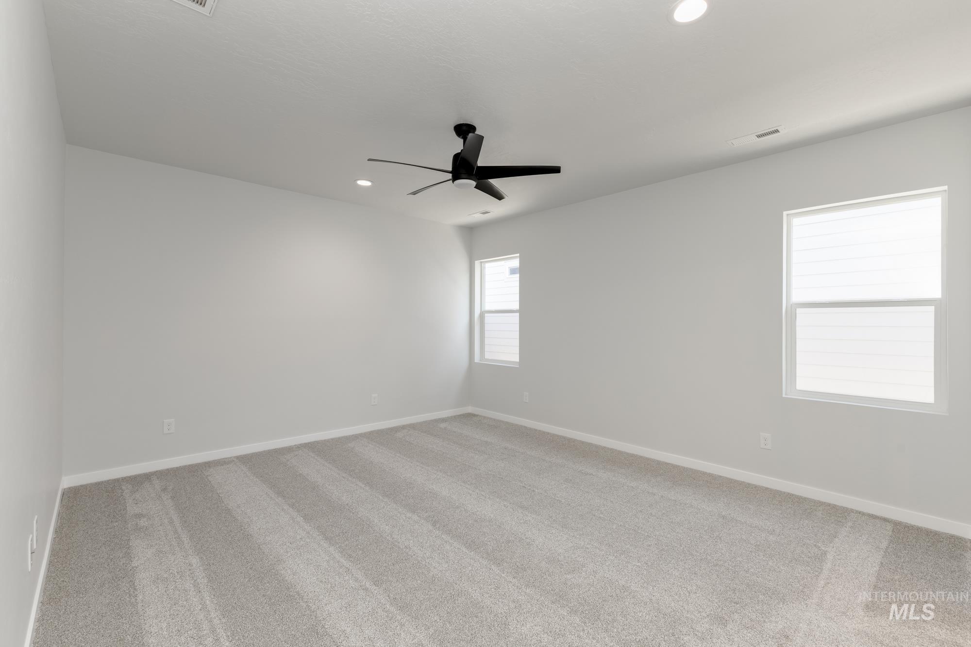 Unfurnished room featuring light carpet, recessed lighting, and a ceiling fan