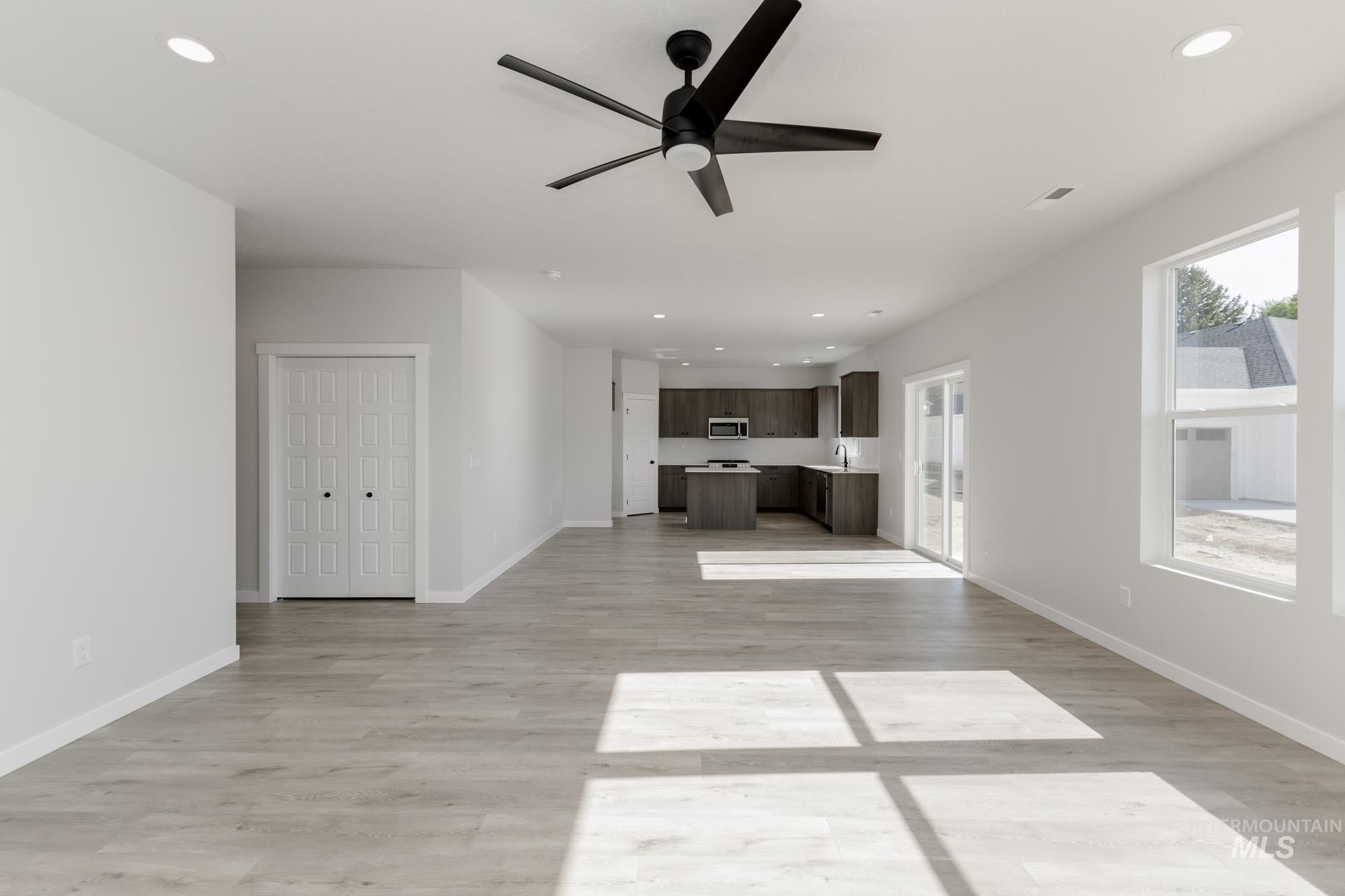 Unfurnished living room with recessed lighting, light wood-type flooring, and a ceiling fan