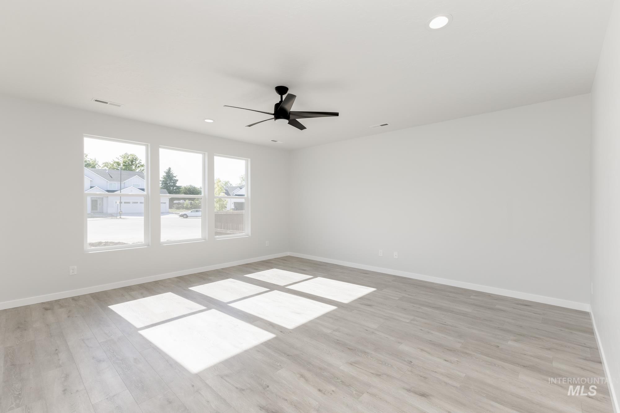 Empty room with light wood-type flooring, recessed lighting, and ceiling fan