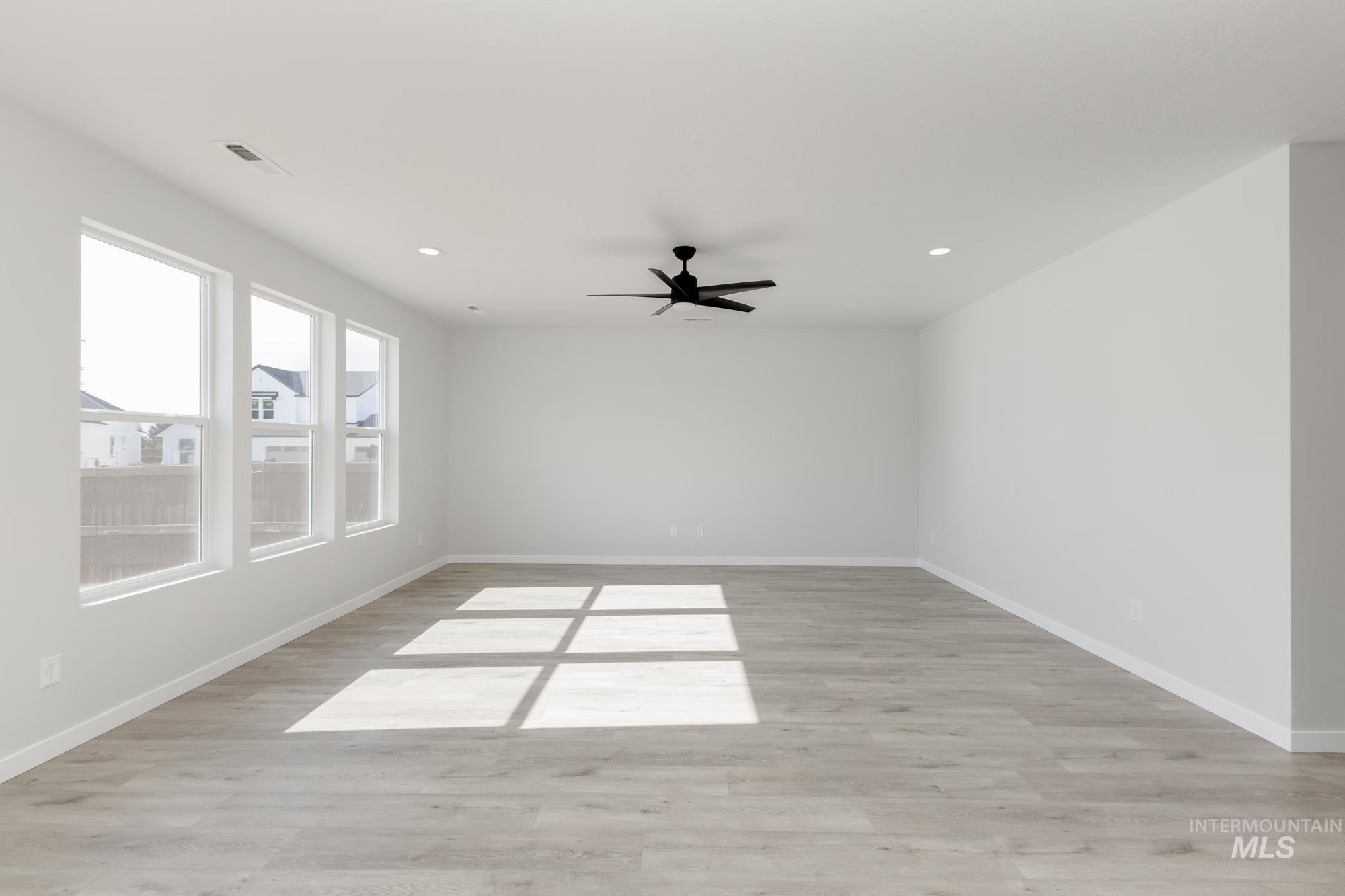 Unfurnished room with light wood-style flooring, recessed lighting, and a ceiling fan