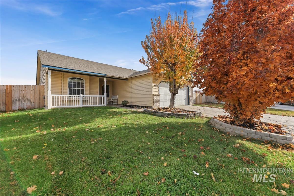 View of front of home with concrete driveway and a garage