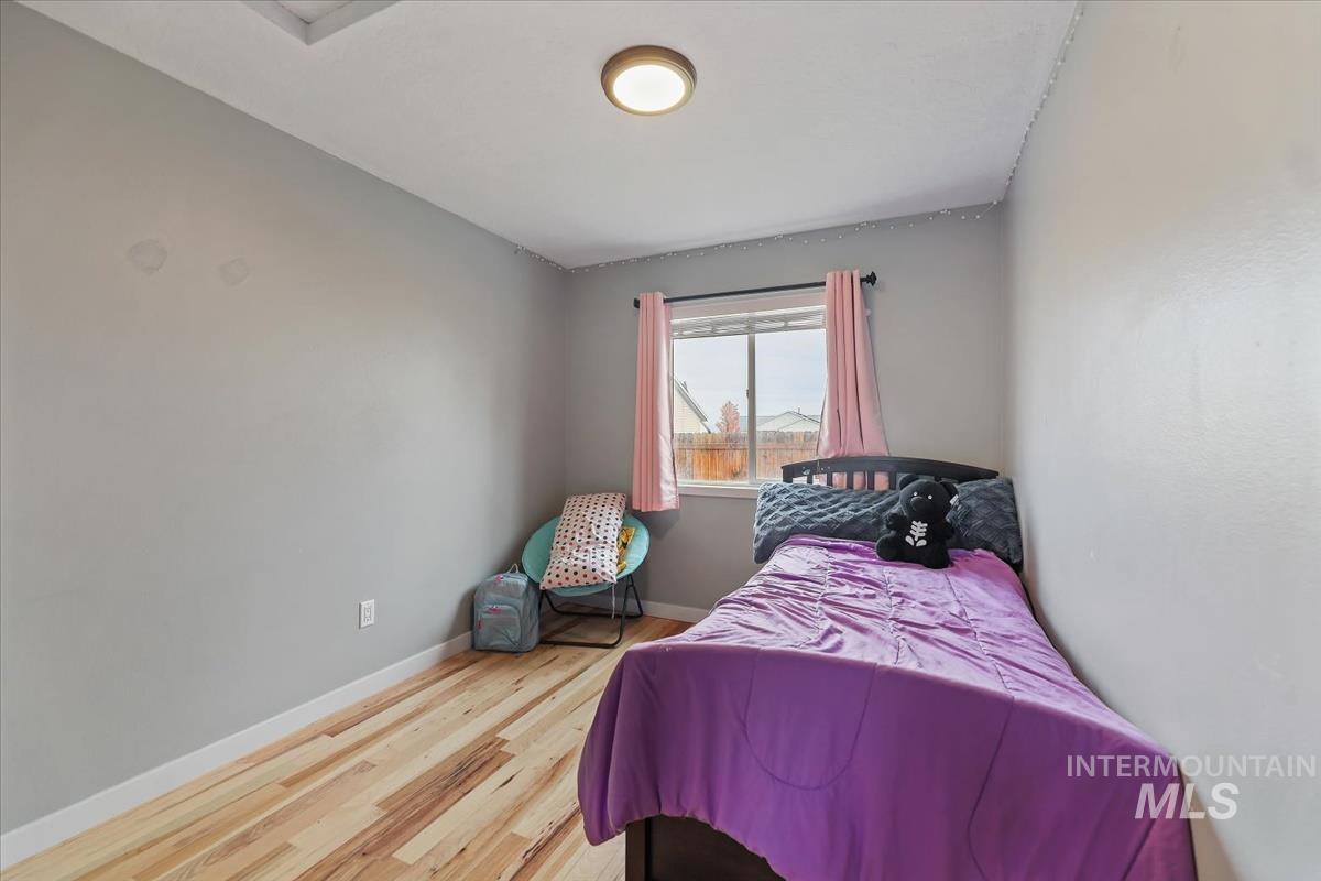 Bedroom featuring baseboards and wood finished floors