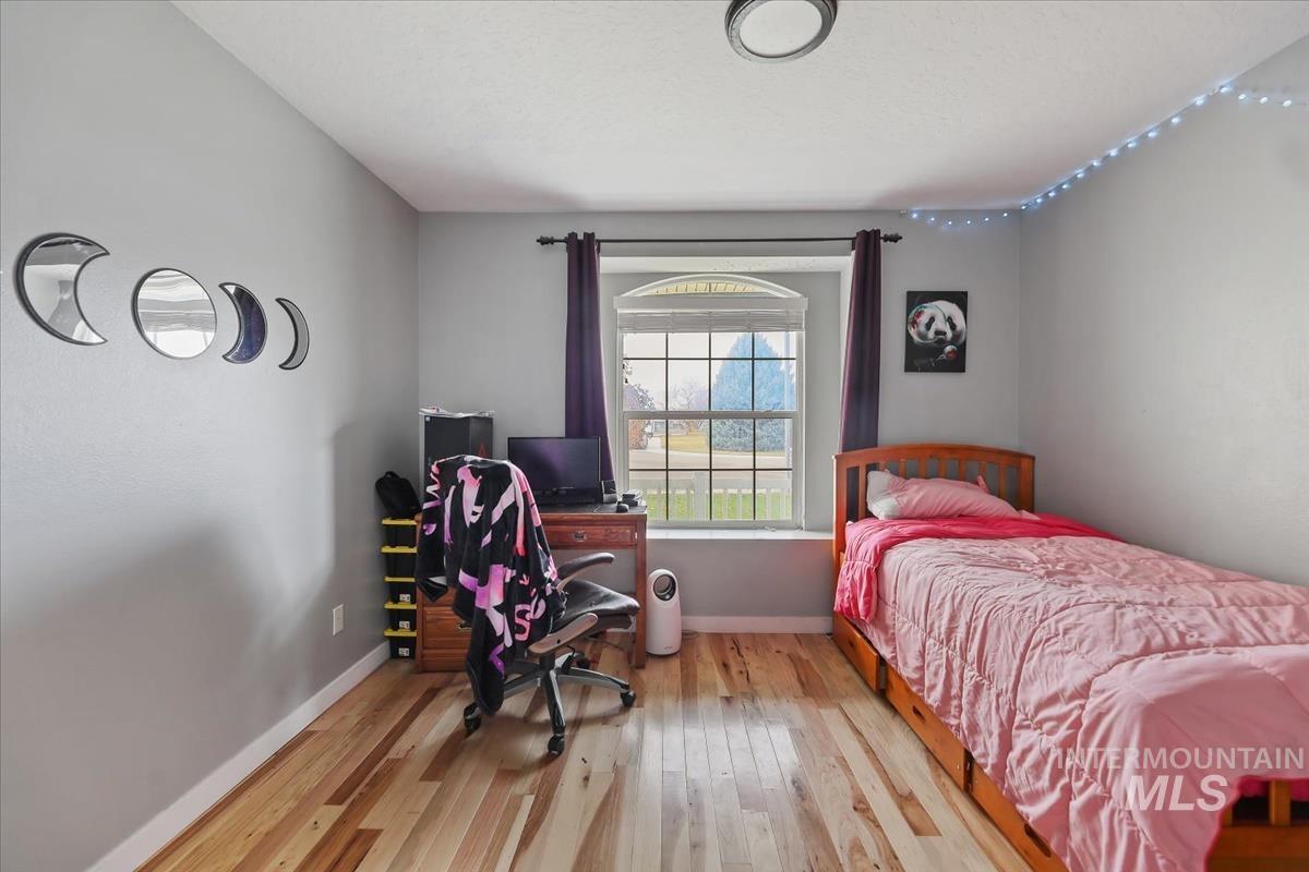 Bedroom featuring light wood-style floors and a desk