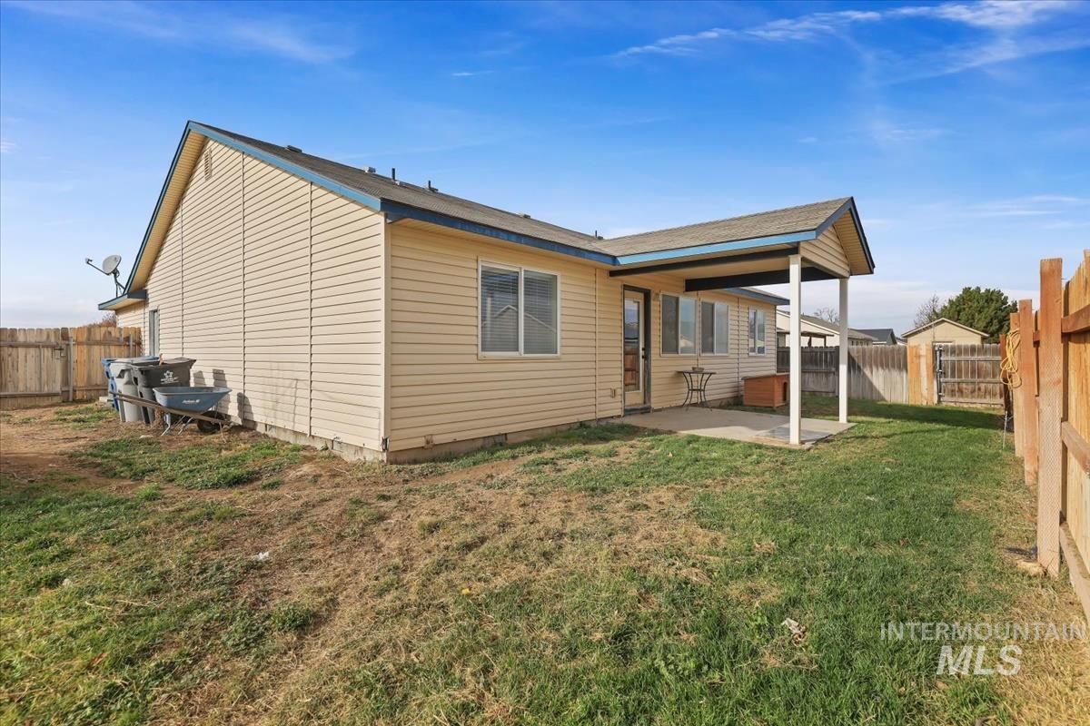 Rear view of house featuring a fenced backyard, a patio, and crawl space