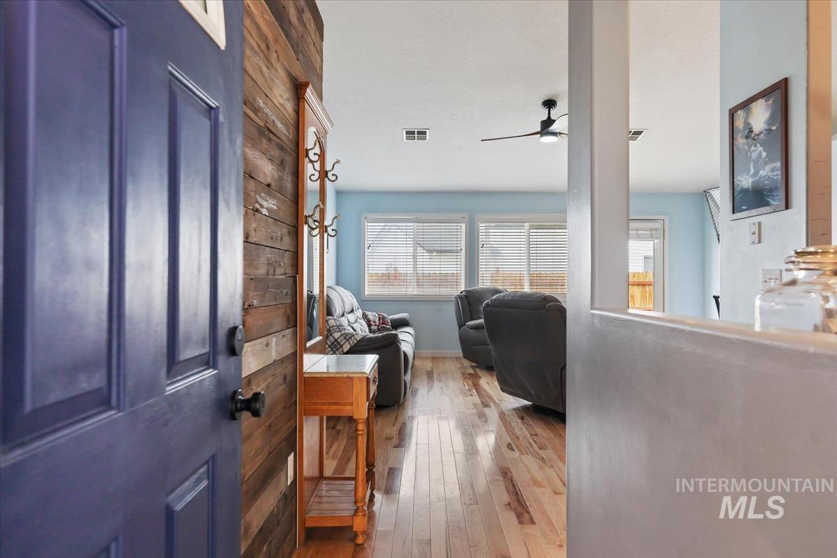 Entrance foyer featuring hardwood / wood-style flooring, plenty of natural light, and a ceiling fan