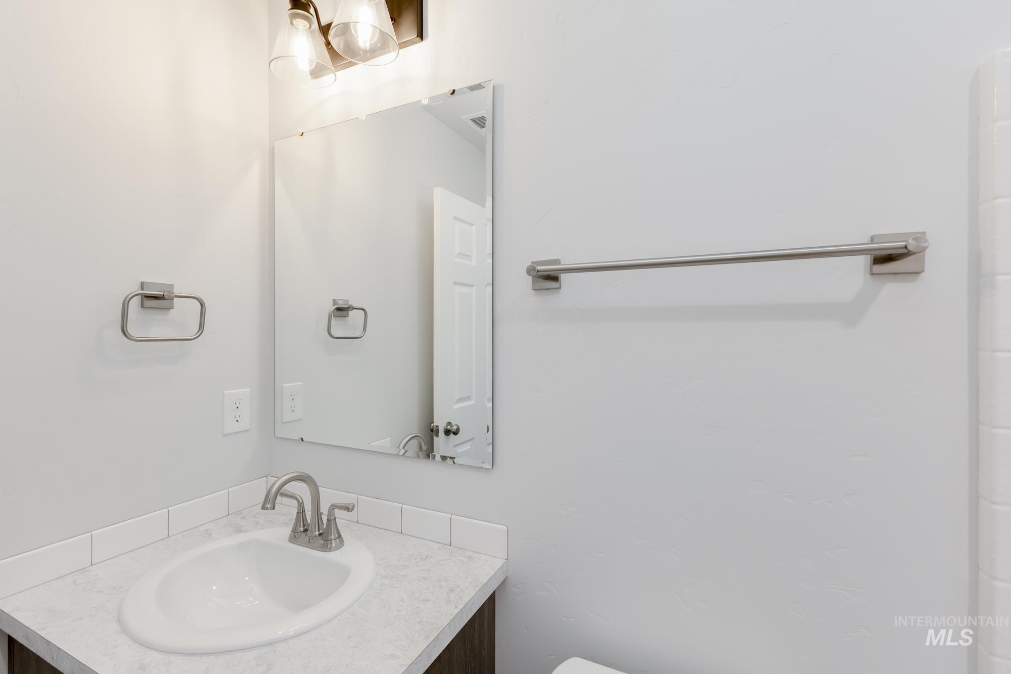 Half bathroom featuring vanity