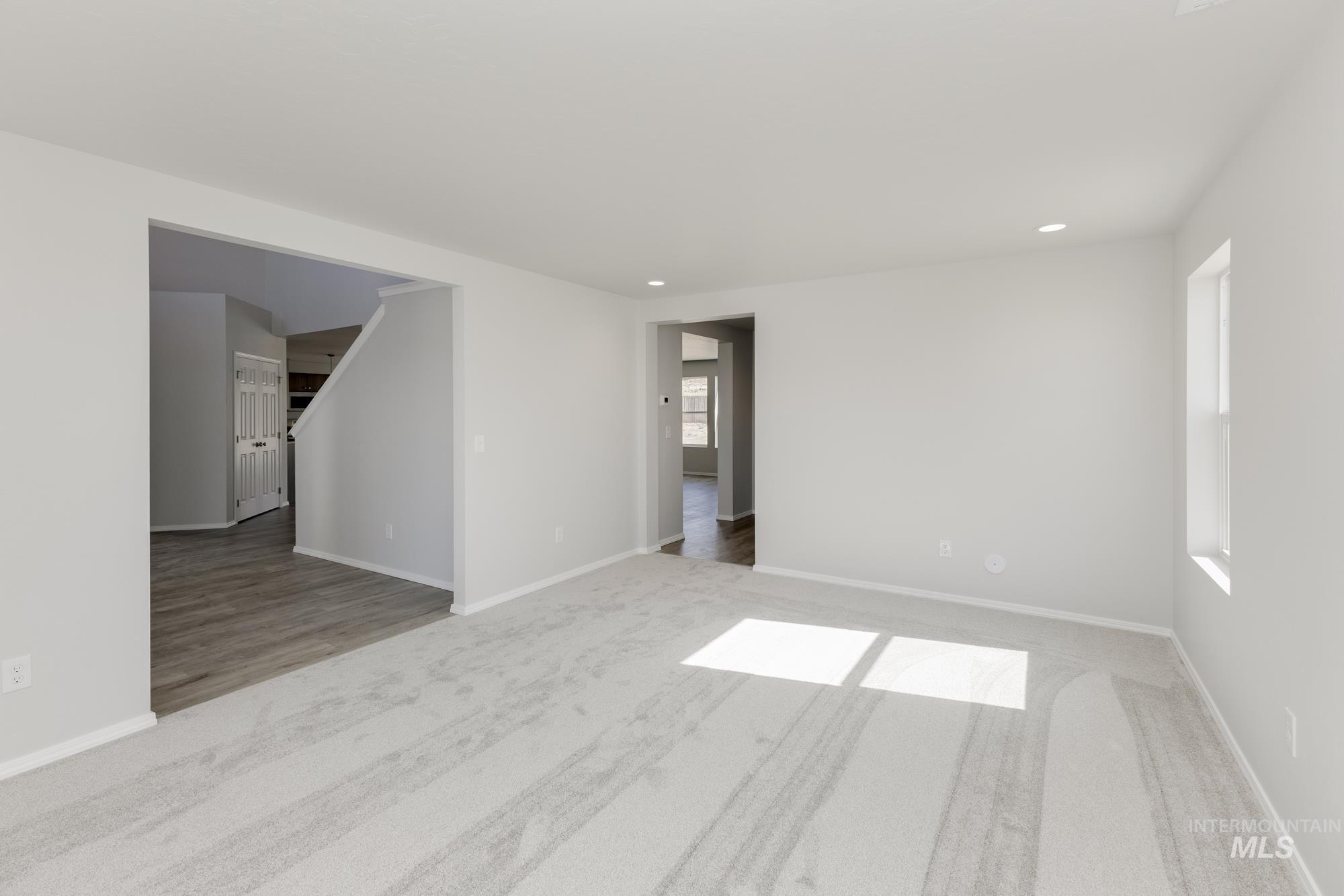 Empty room featuring light colored carpet and recessed lighting