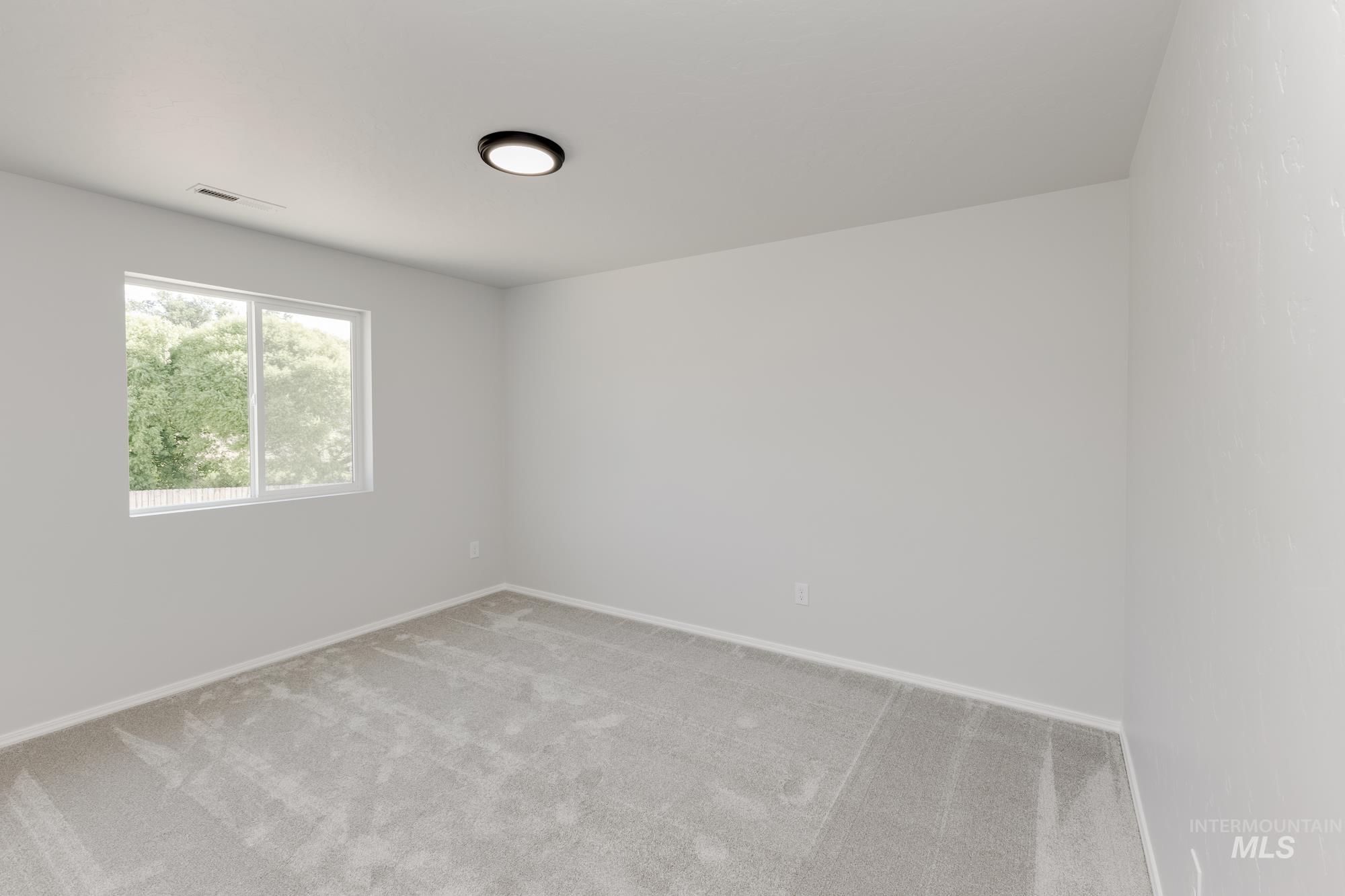 Empty room with carpet flooring and baseboards