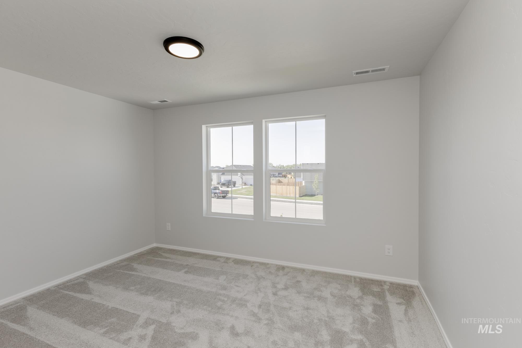 Spare room with carpet flooring and baseboards