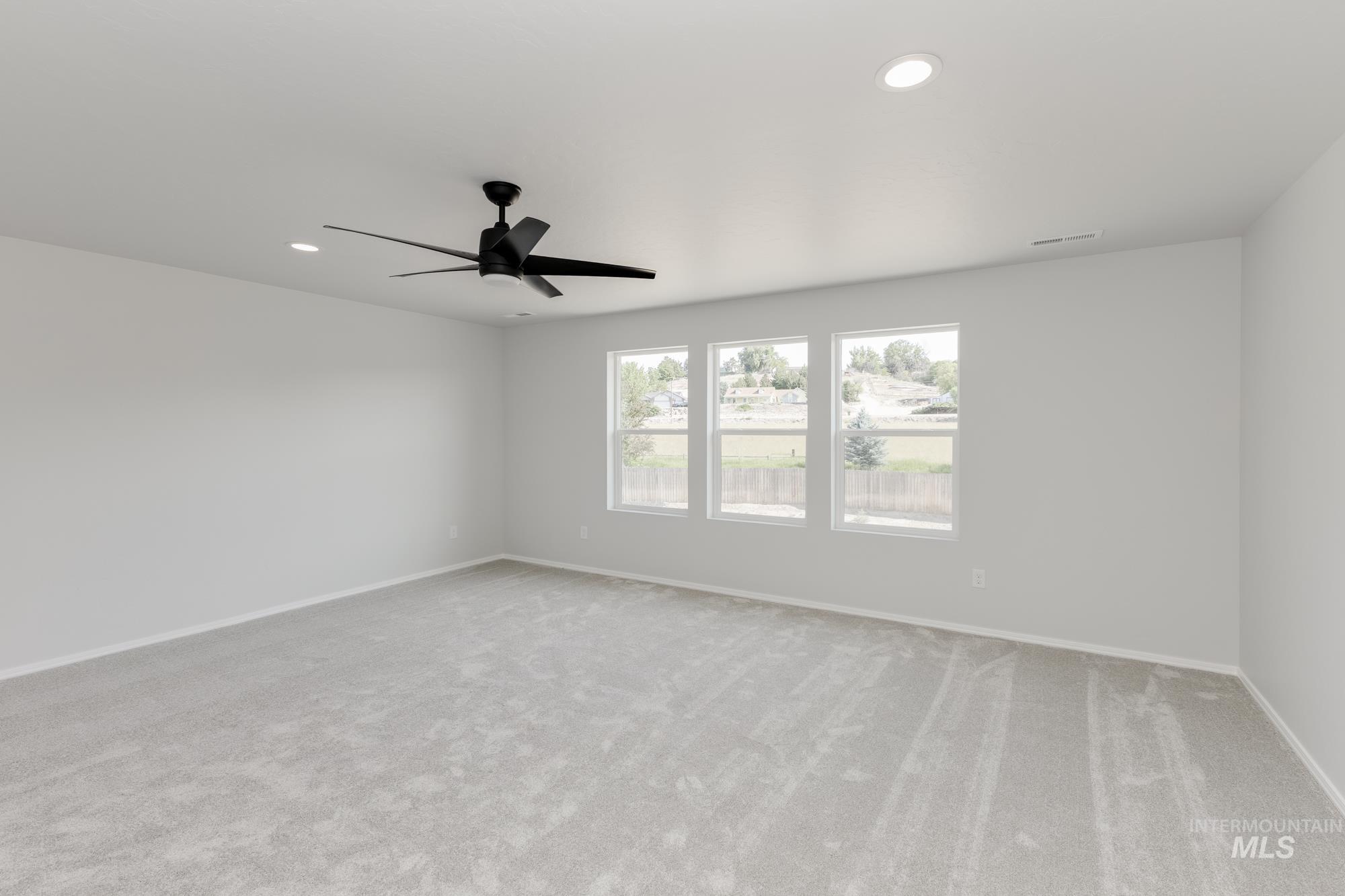 Empty room with light carpet, recessed lighting, and ceiling fan