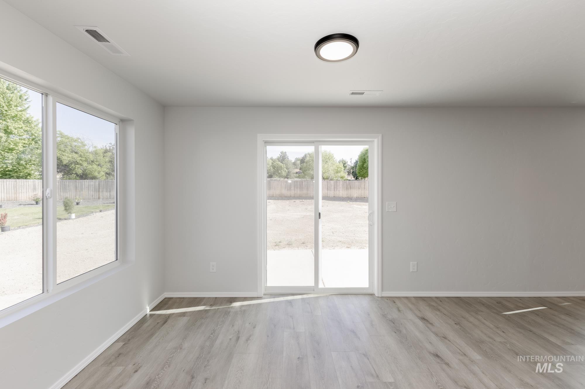 Empty room with light wood-style floors and baseboards