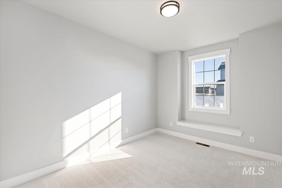 Unfurnished room with carpet floors and baseboards