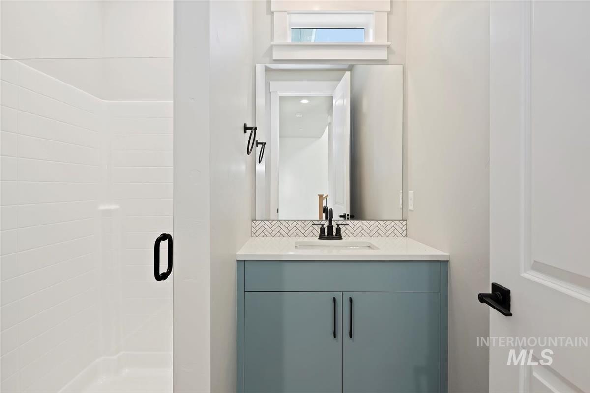 Bathroom with vanity and a stall shower