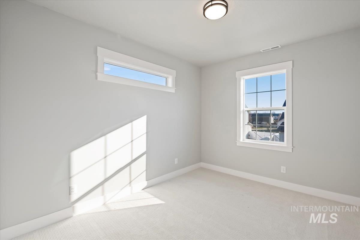 Carpeted empty room with healthy amount of natural light