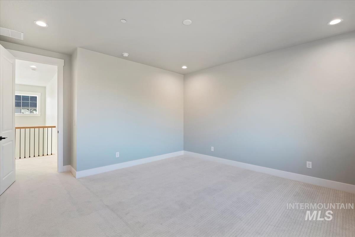 Unfurnished room featuring light colored carpet and recessed lighting