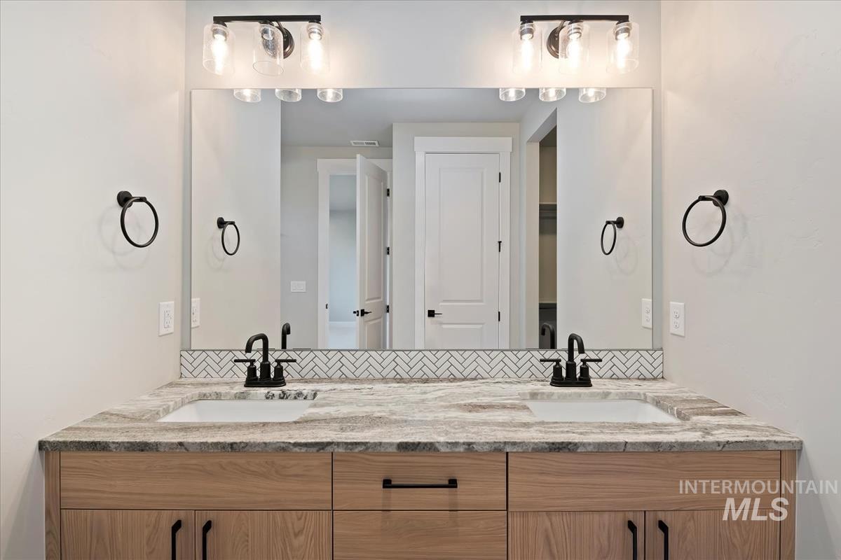 Full bath featuring double vanity