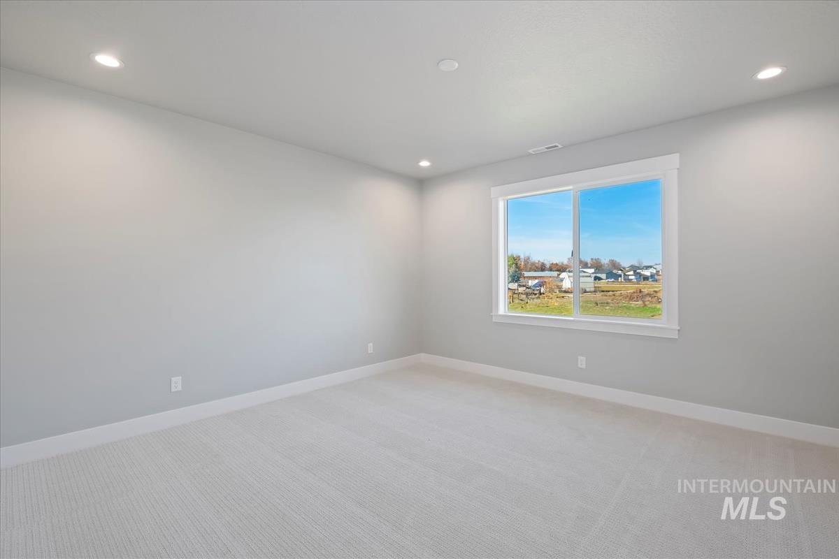 Unfurnished room featuring light carpet and recessed lighting