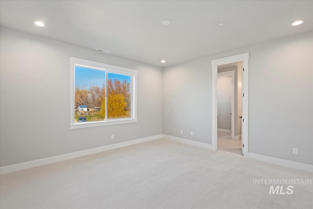 Unfurnished room featuring light colored carpet and recessed lighting