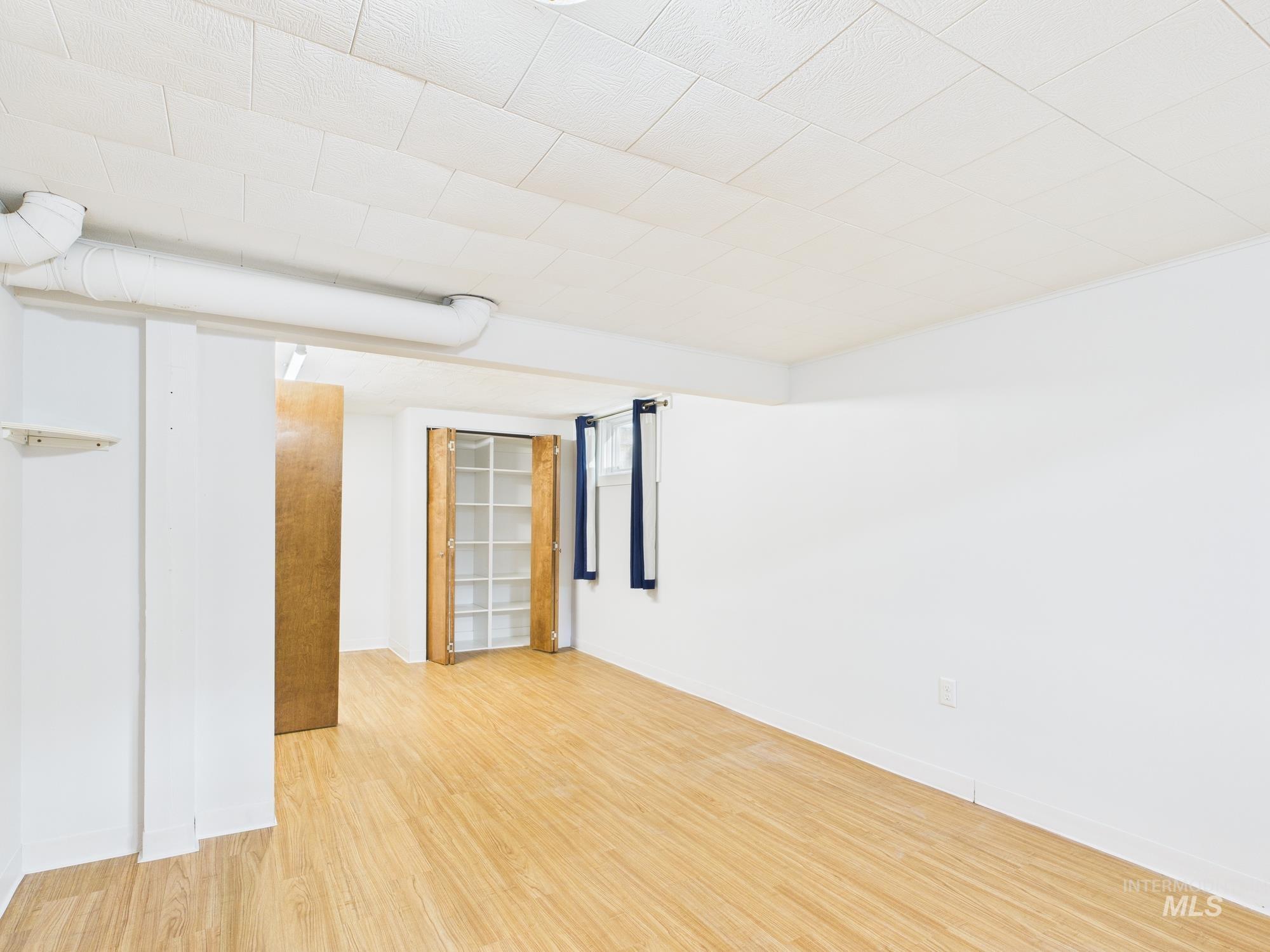 Empty room featuring light wood-style floors and baseboards