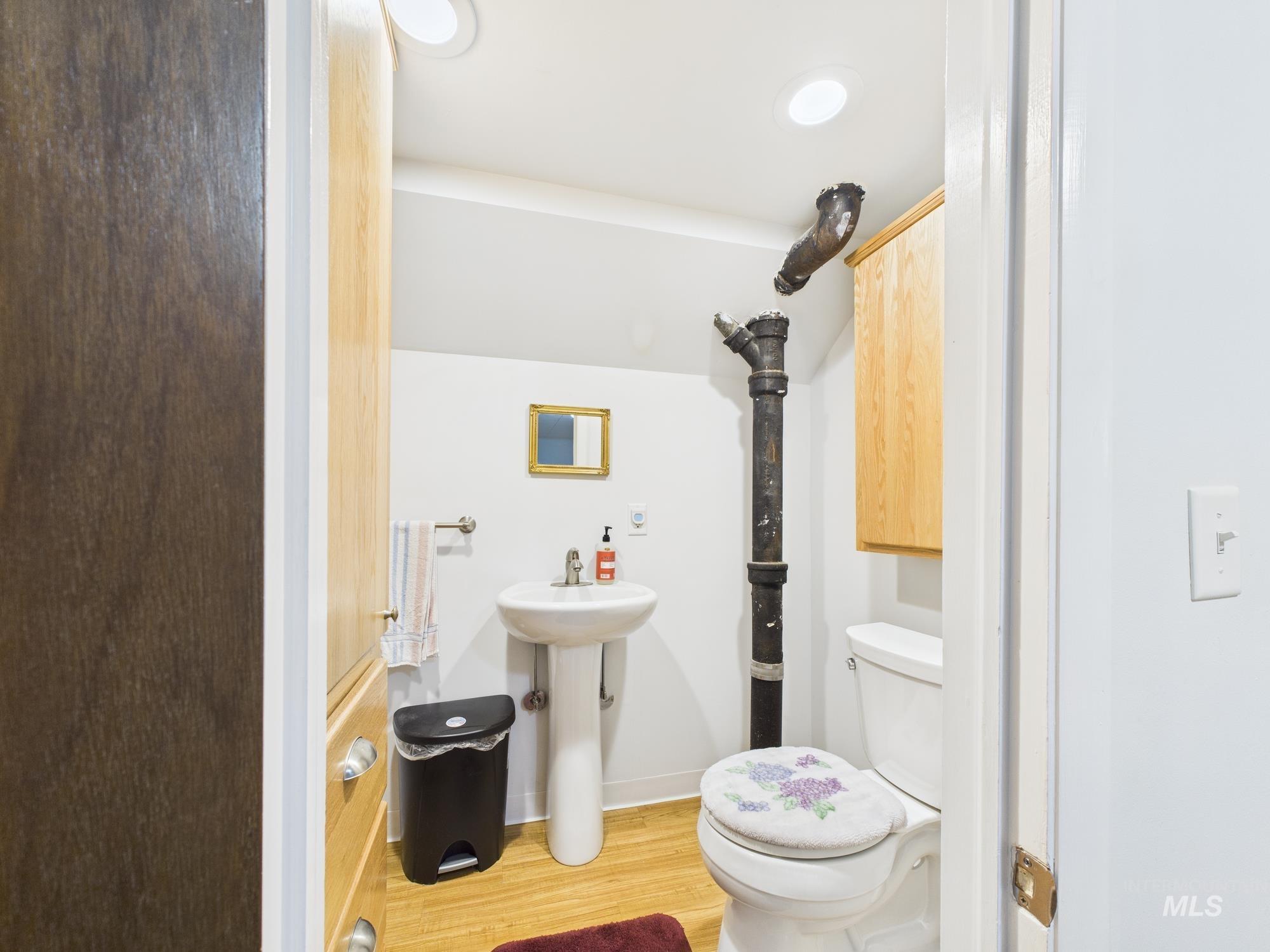 Bathroom with light wood-style floors and toilet