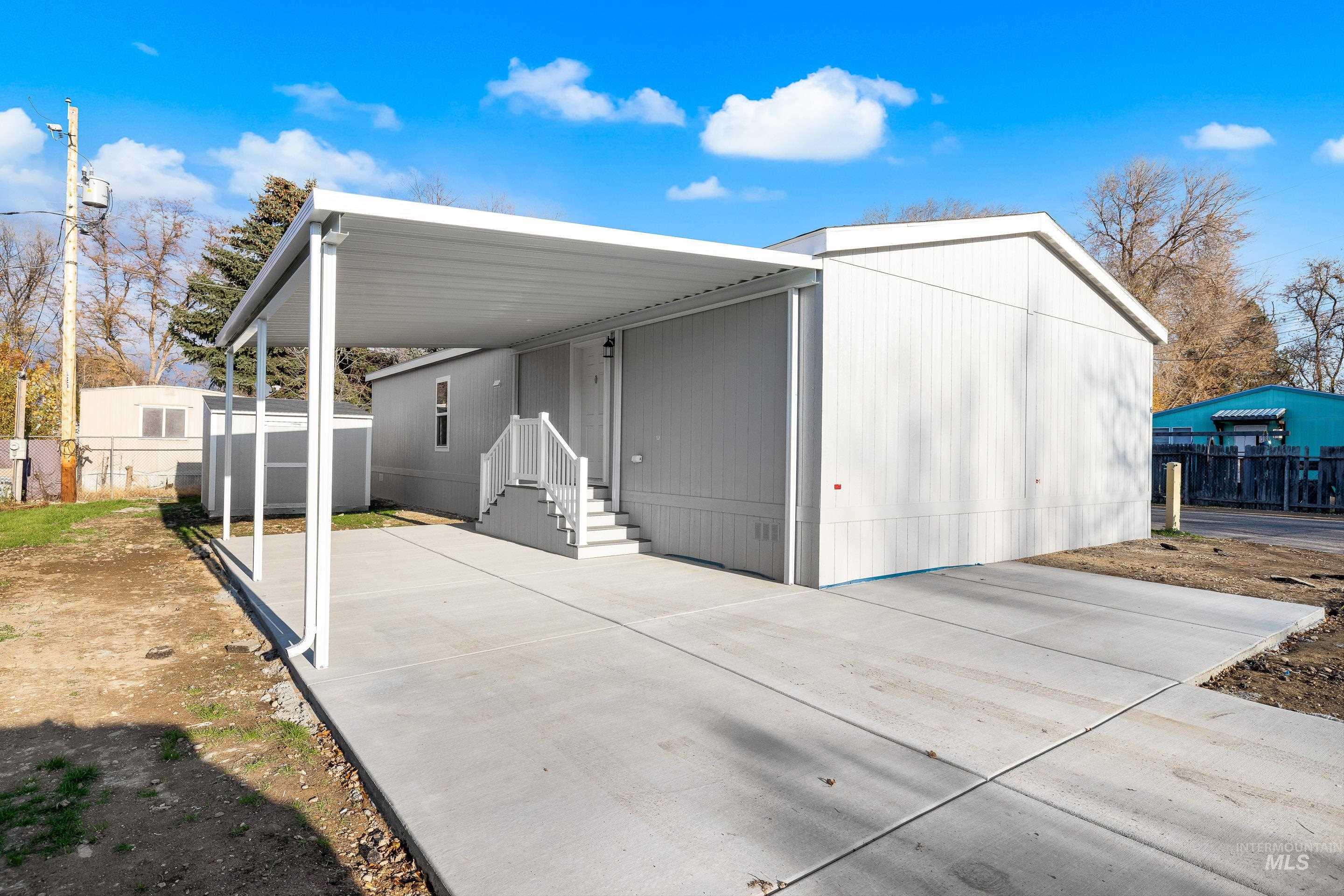 View of front of home with a carport and concrete driveway