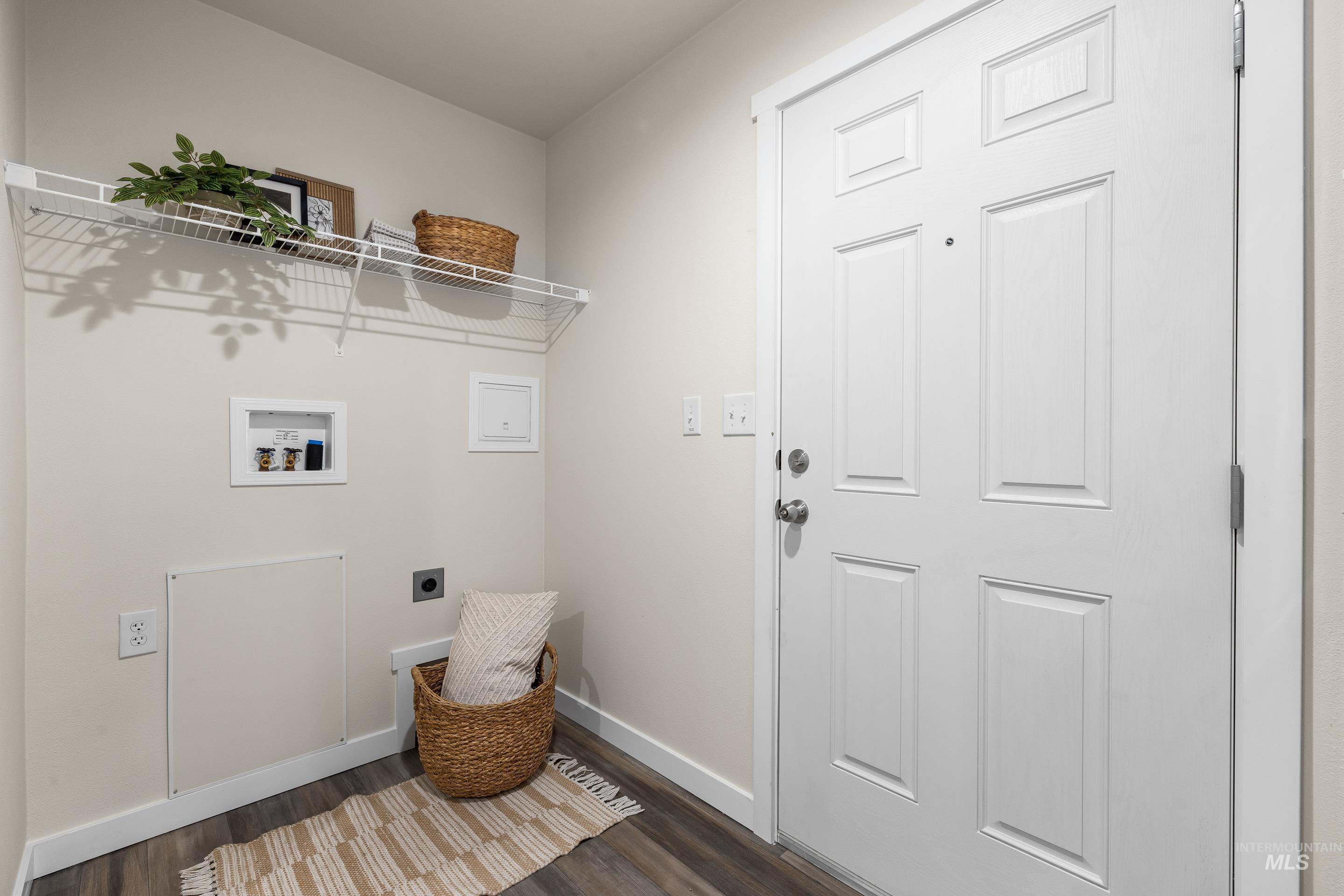 Laundry area featuring hookup for an electric dryer, dark wood-type flooring, and hookup for a washing machine