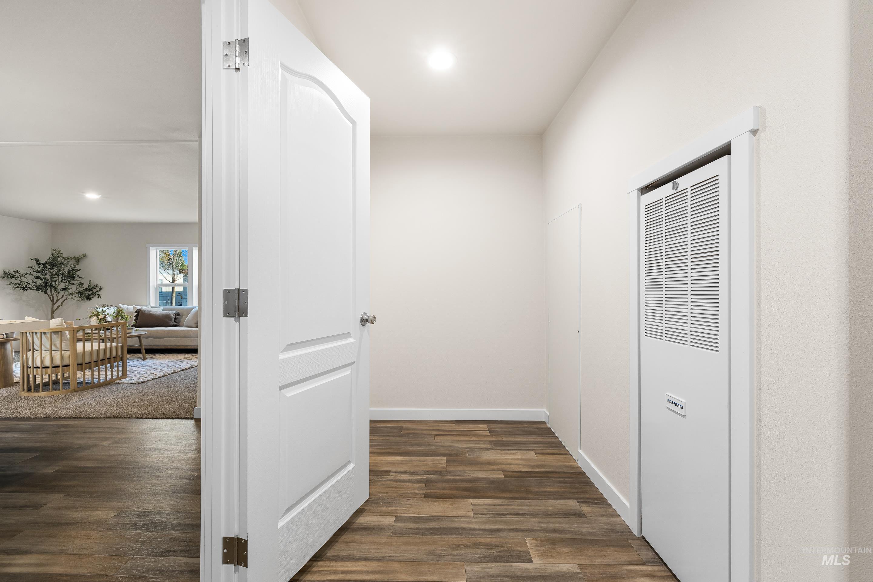 Hall featuring recessed lighting, a heating unit, and dark wood finished floors
