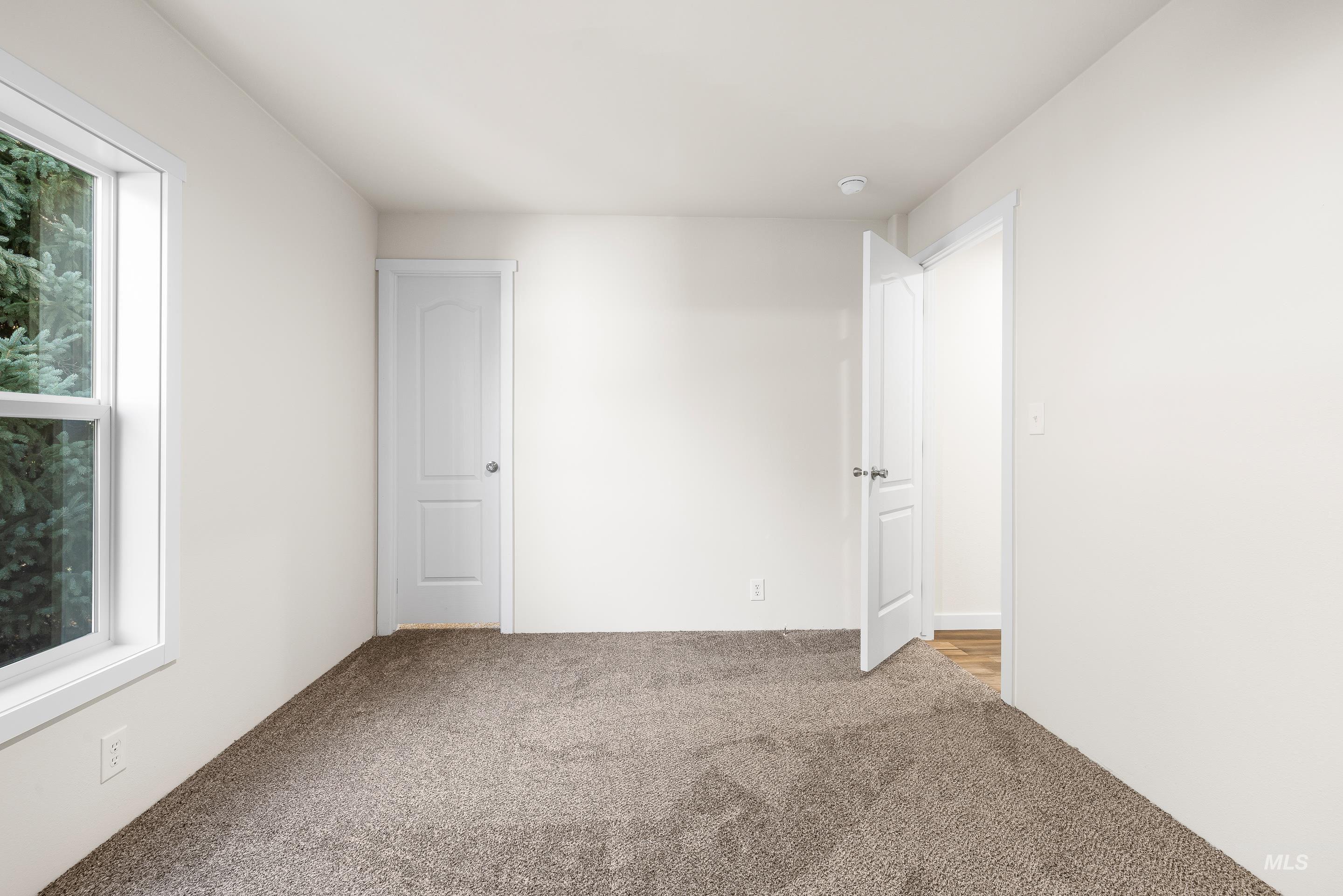 Empty room with carpet floors