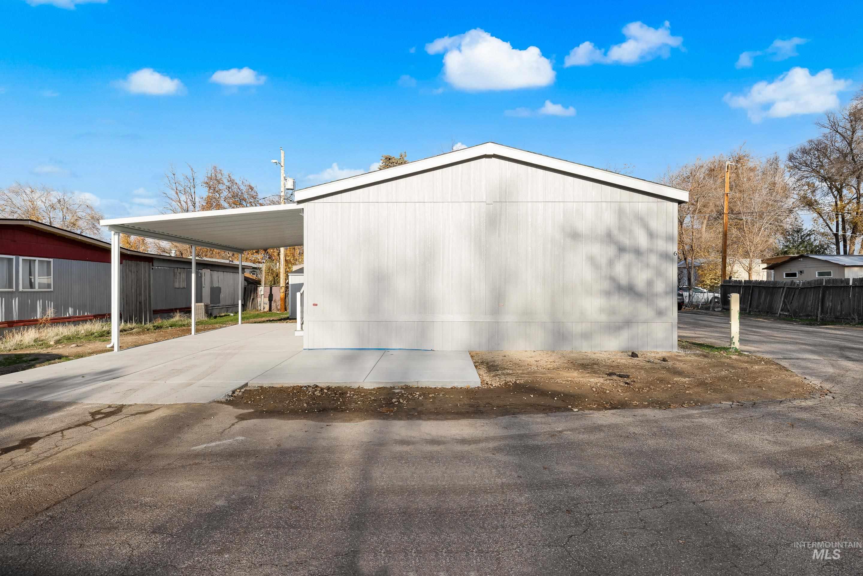 View of home's exterior with a carport and driveway