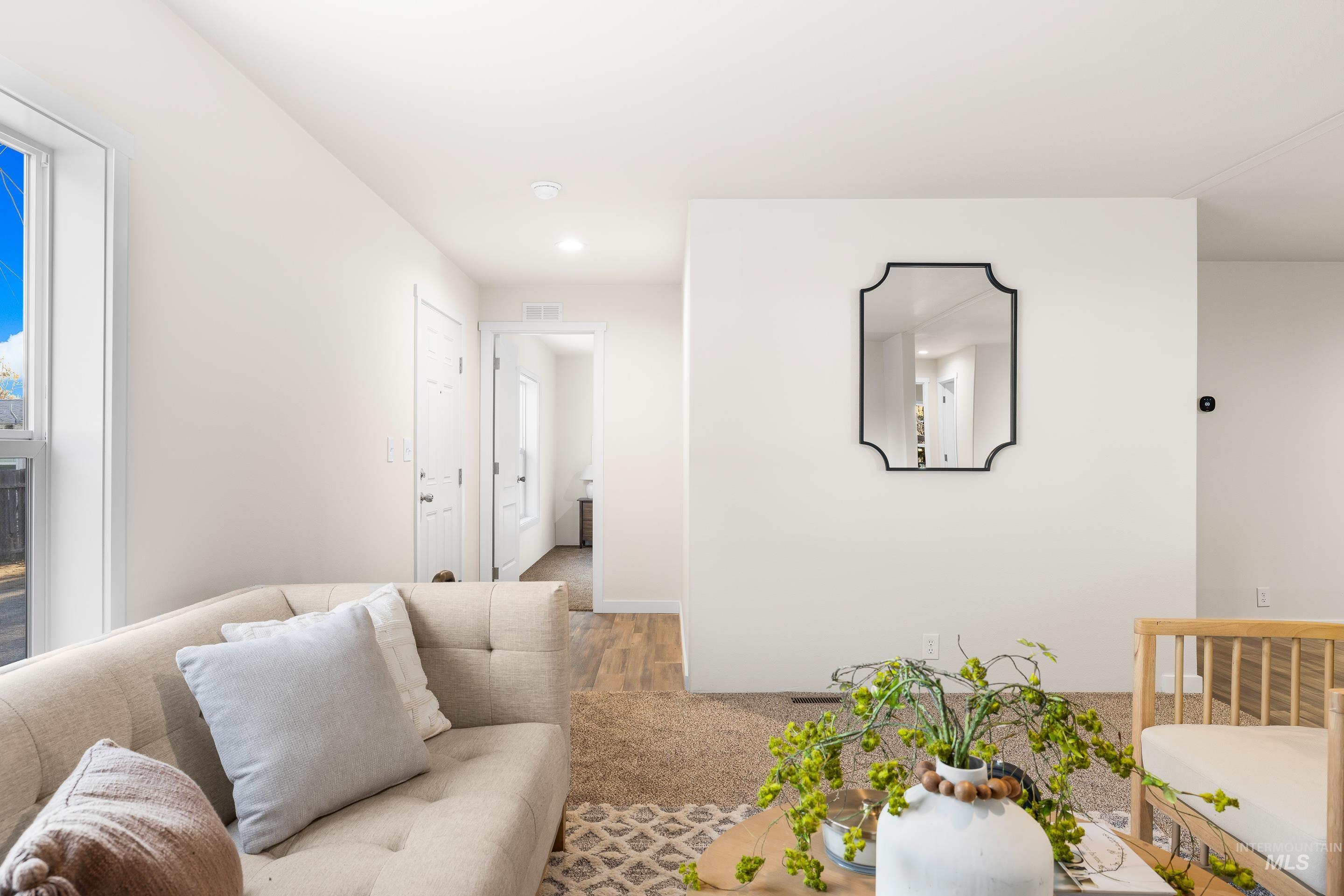 Living area with wood finished floors and recessed lighting