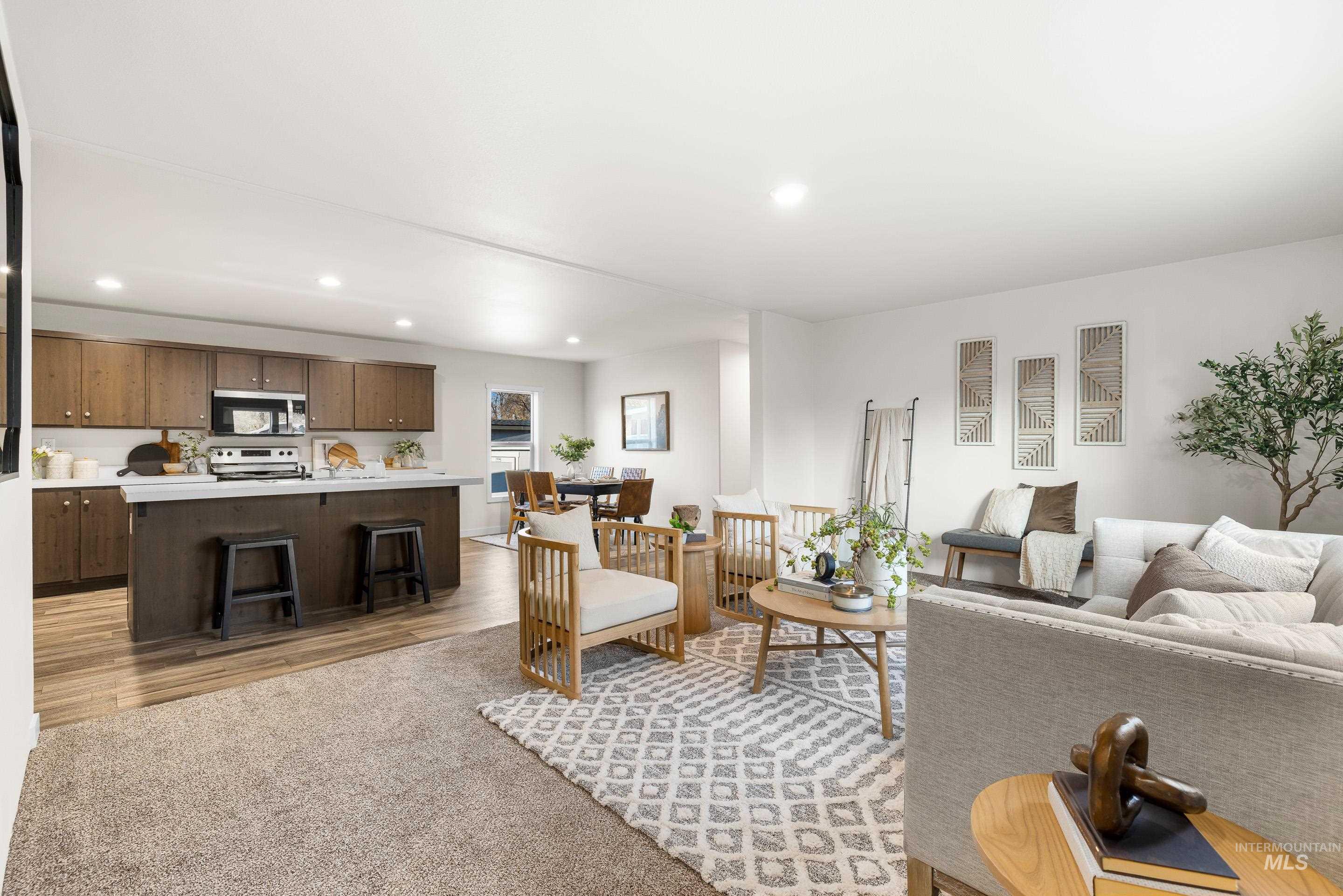 Living area with recessed lighting, light carpet, and light wood-style flooring