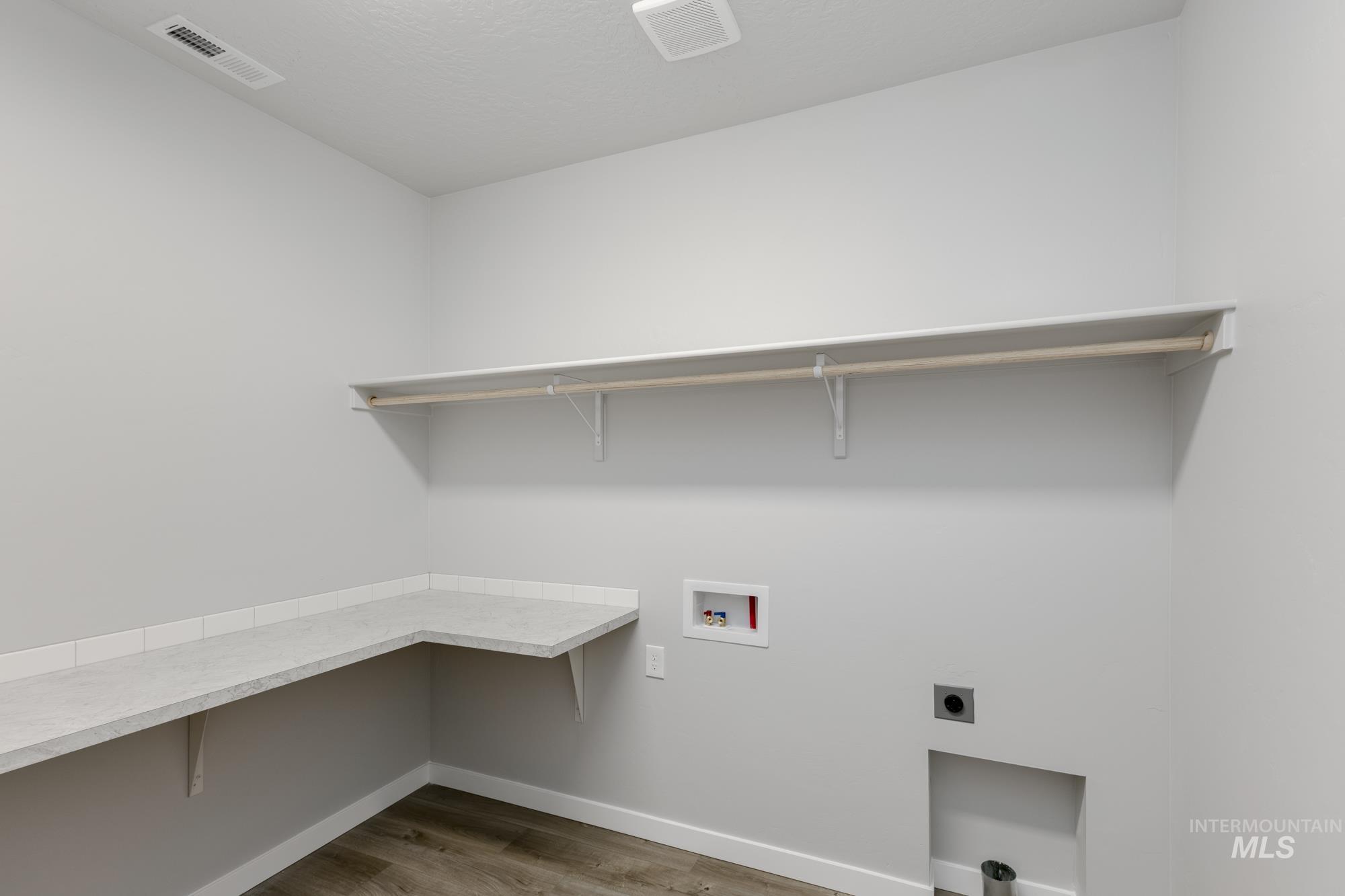 Washroom with light wood finished floors, washer hookup, and electric dryer hookup