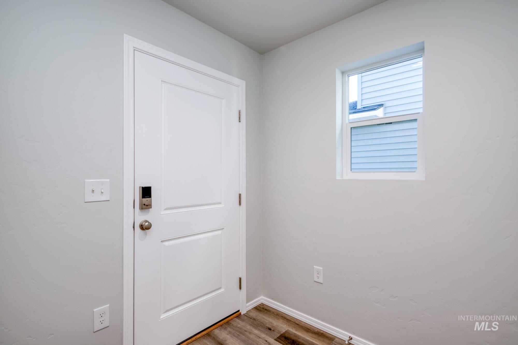 Entryway featuring wood finished floors and baseboards
