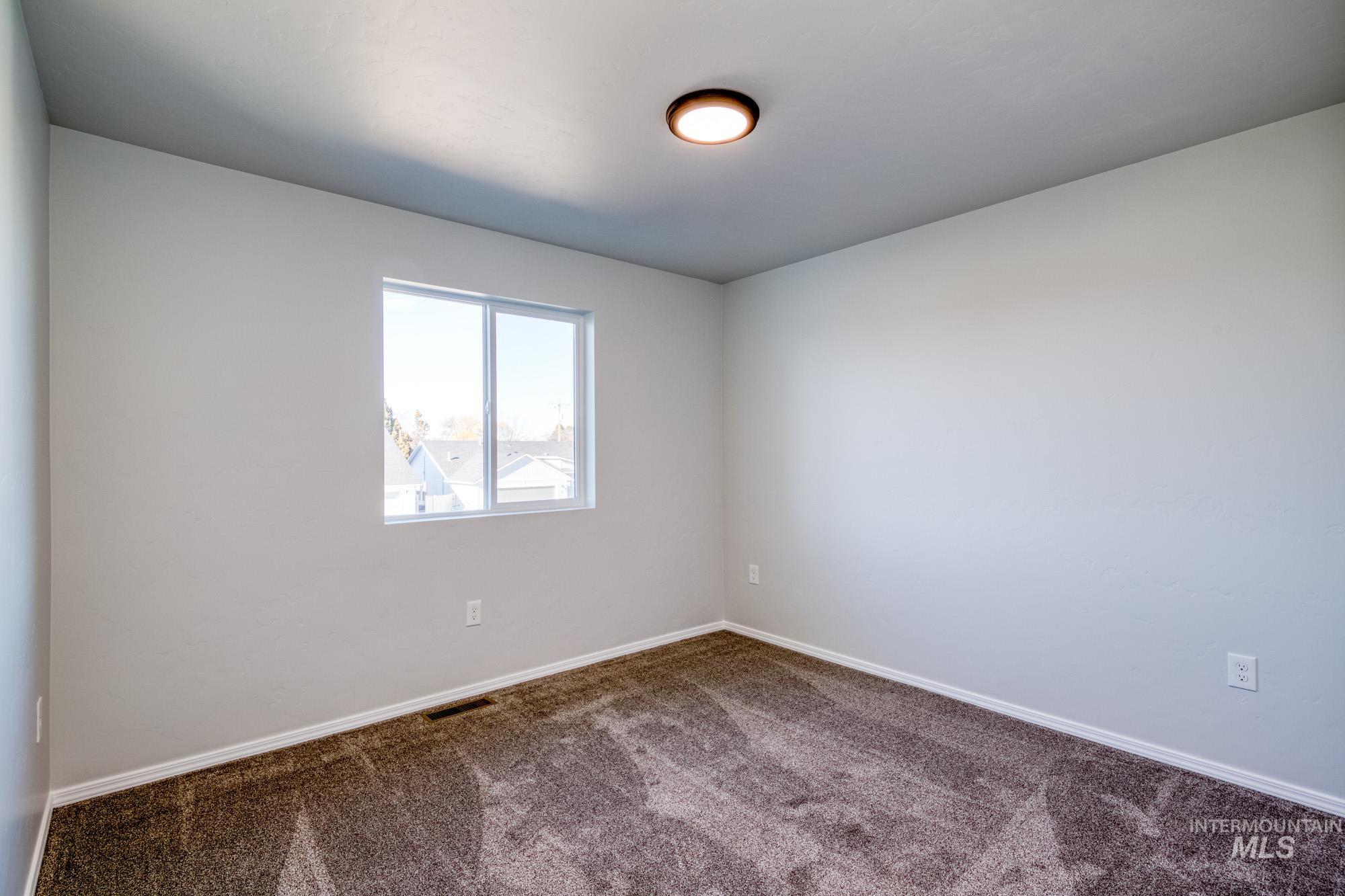 Spare room with carpet floors and baseboards