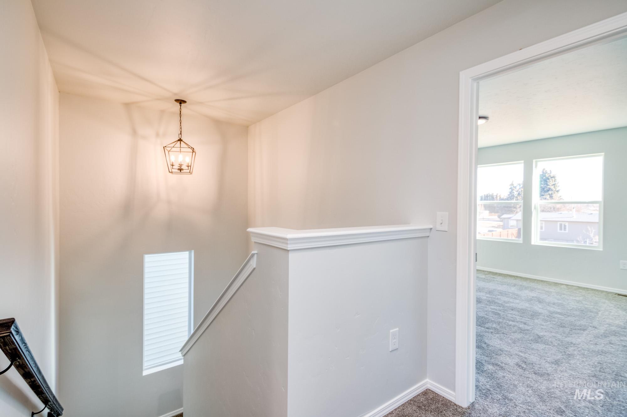 Stairs with carpet flooring and baseboards