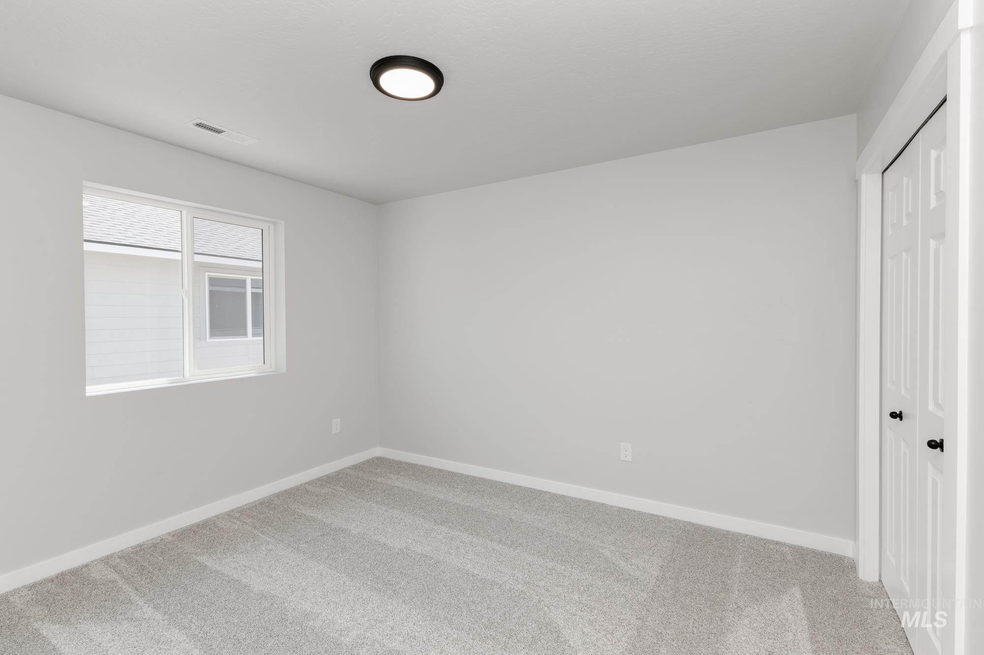 Unfurnished bedroom featuring carpet flooring and a closet
