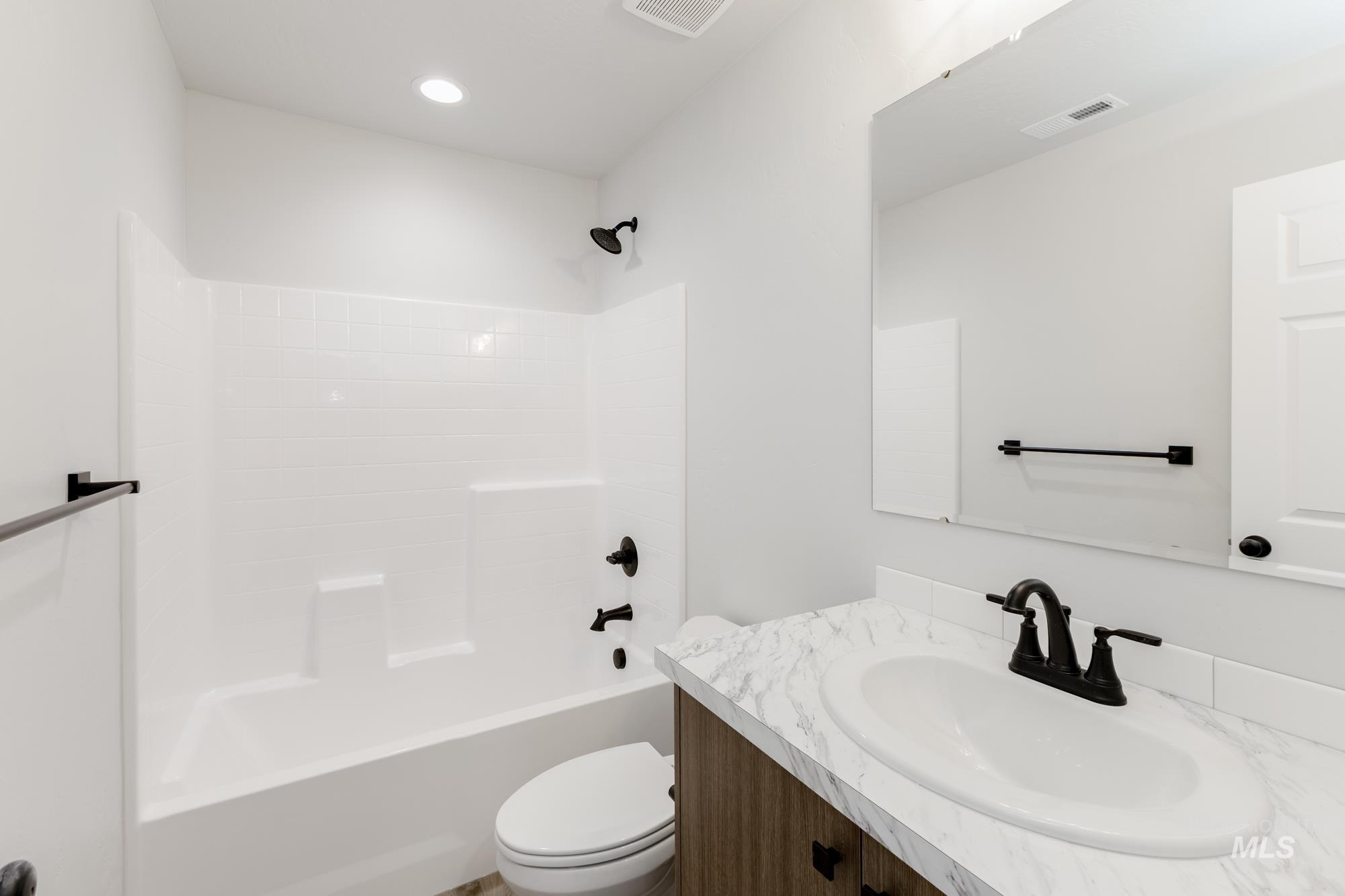 Full bath featuring shower / tub combination, vanity, and recessed lighting