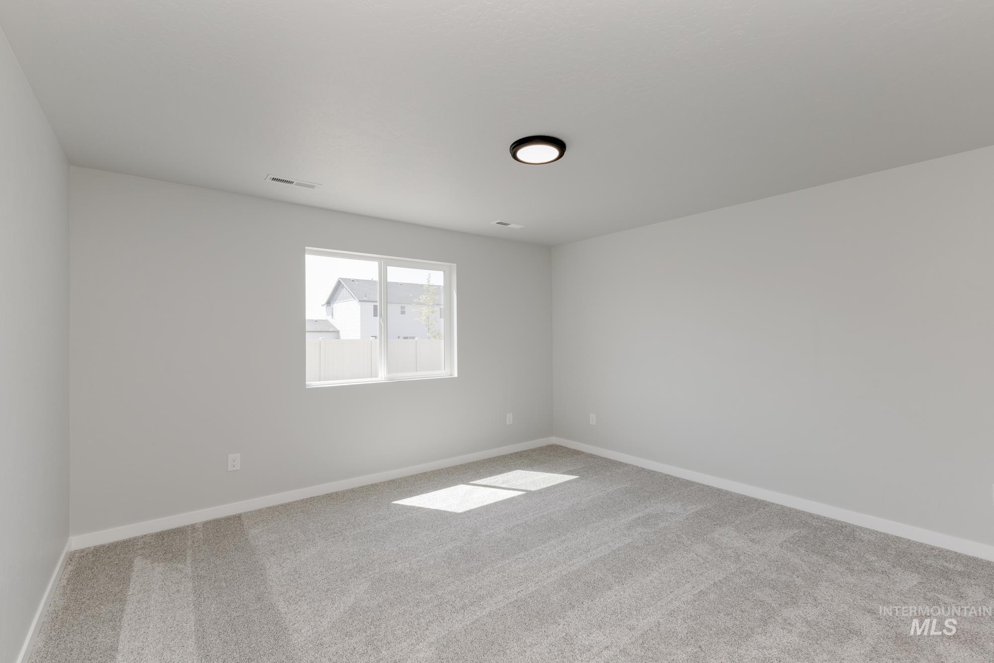 Unfurnished room with carpet