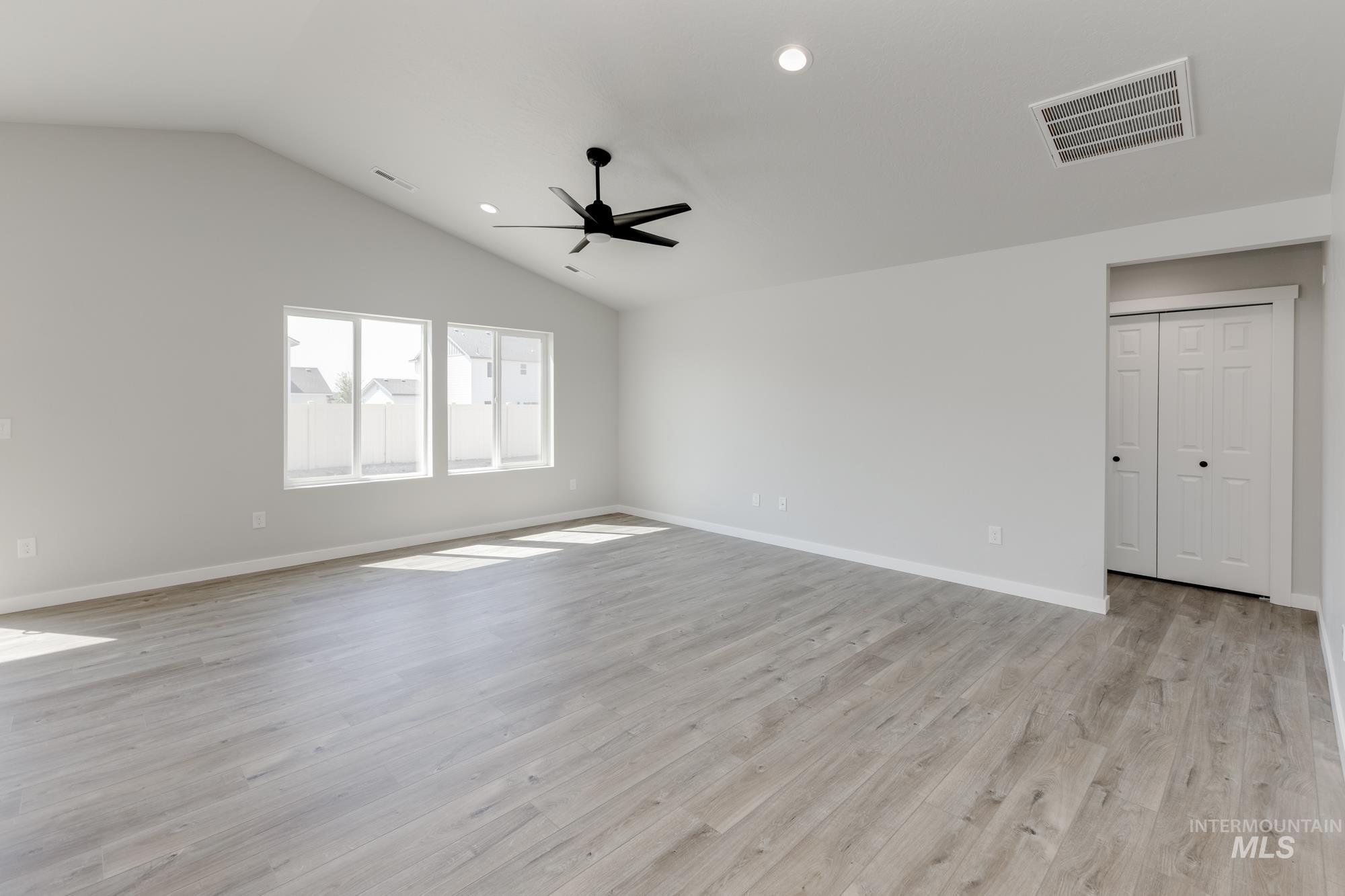 Spare room featuring lofted ceiling, light wood-style floors, recessed lighting, and ceiling fan
