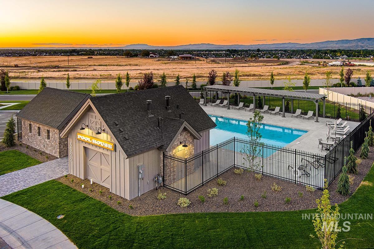 Aerial view at dusk of view of pool and a mountain view