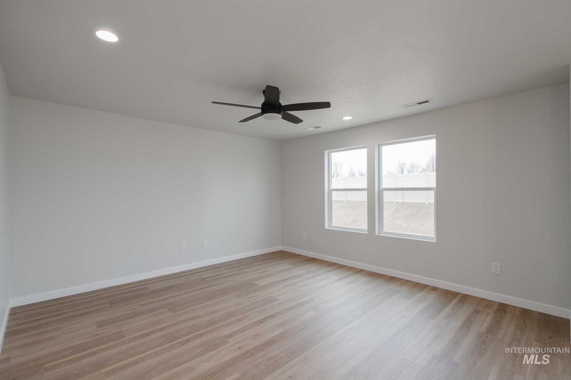 Unfurnished room with light wood-type flooring, recessed lighting, and a ceiling fan