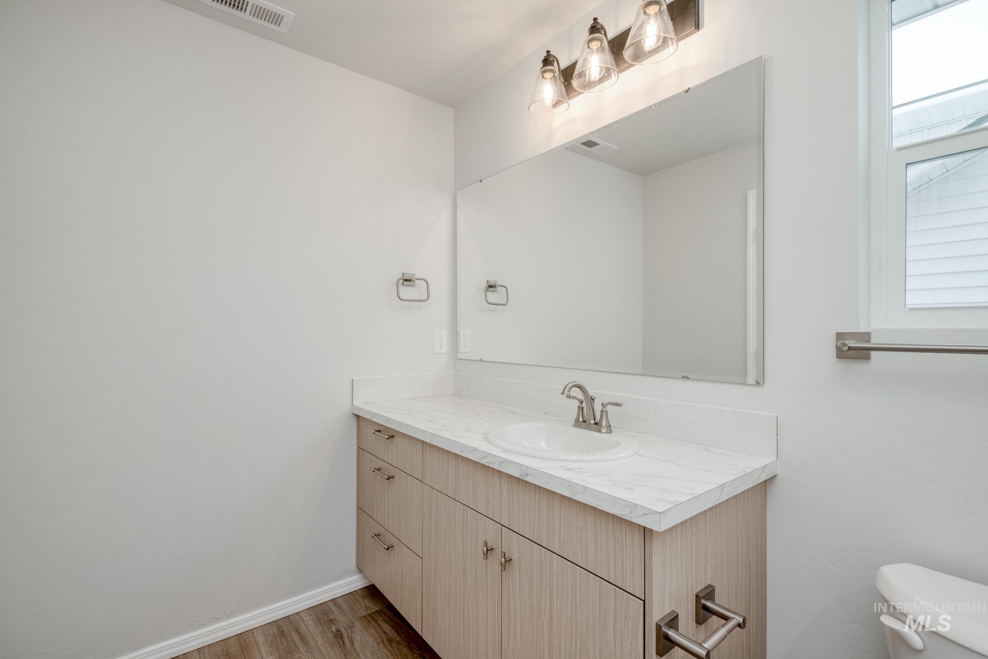 Bathroom with vanity and light wood-type flooring