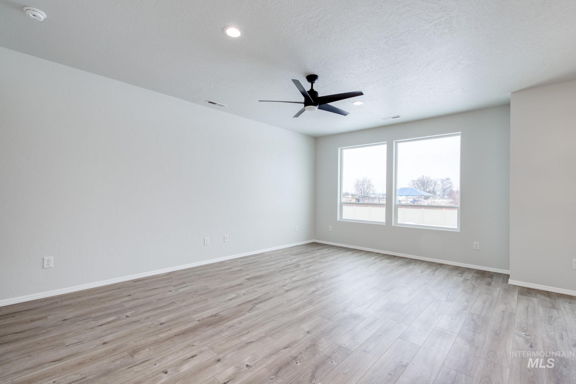 Unfurnished room with light wood-style floors, a textured ceiling, recessed lighting, and ceiling fan