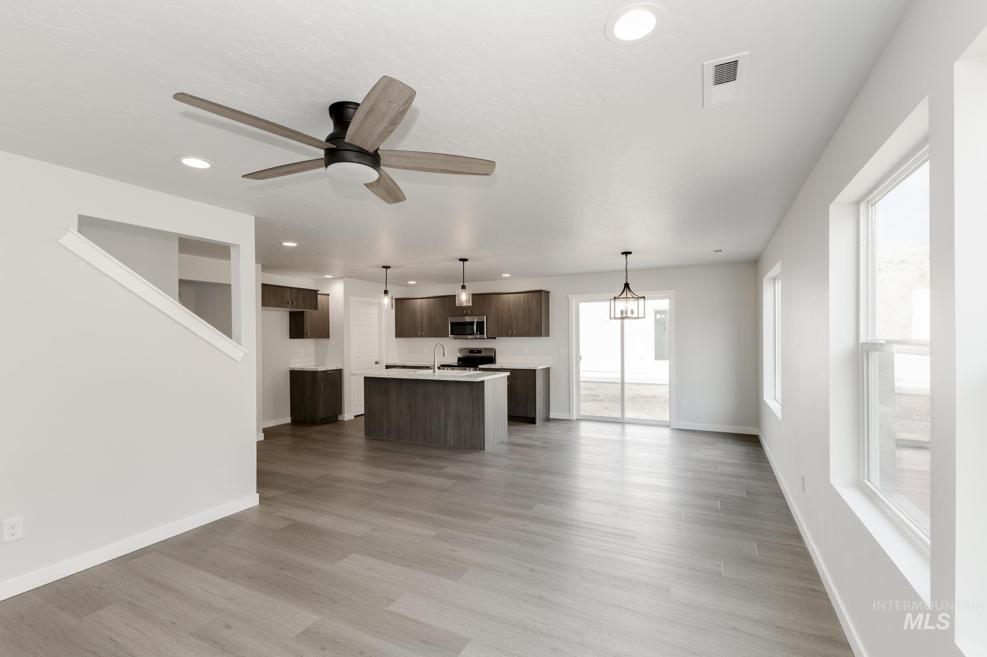 Unfurnished living room with recessed lighting, a ceiling fan, and light wood finished floors