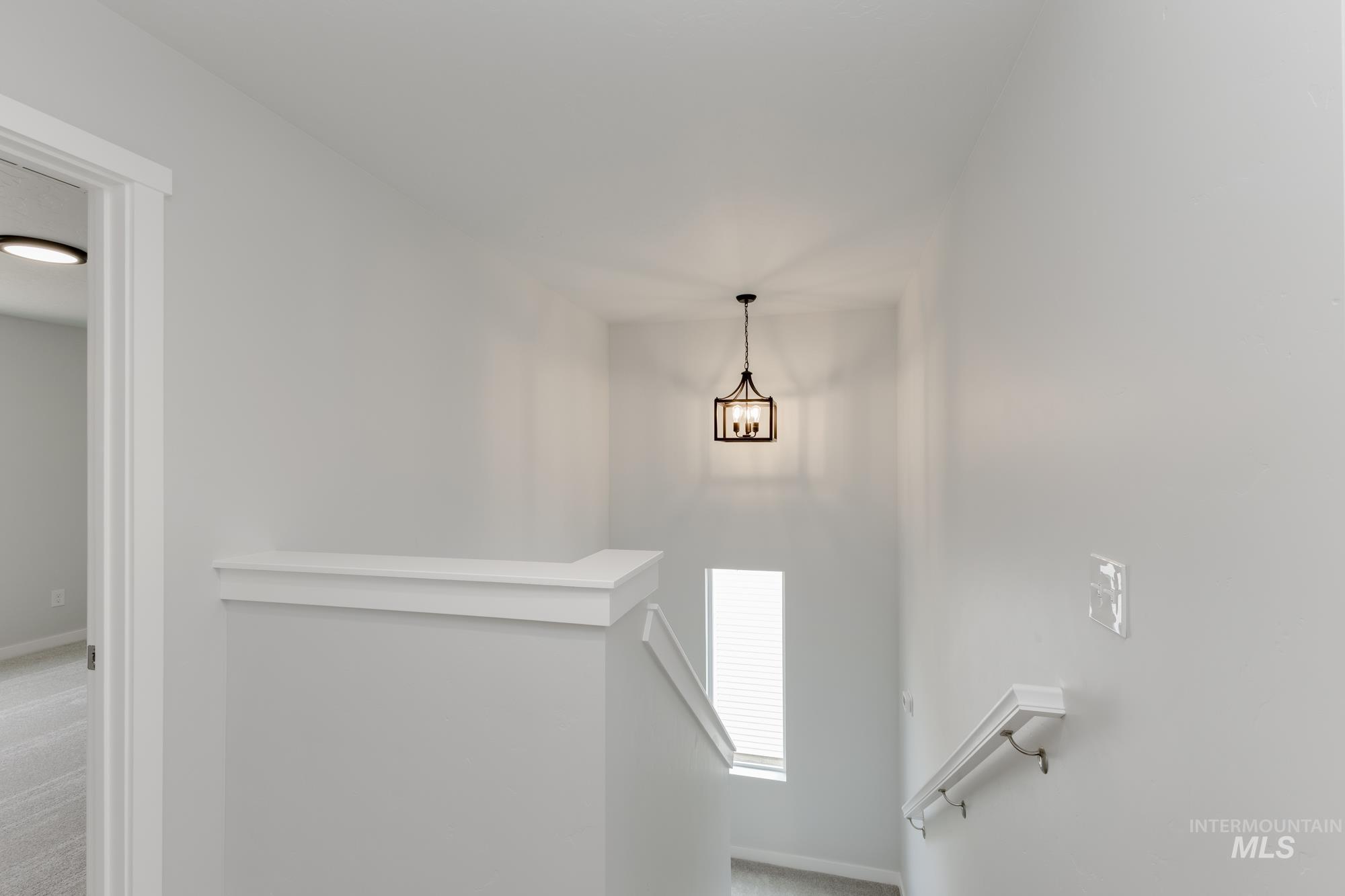 Stairway with carpet flooring and baseboards