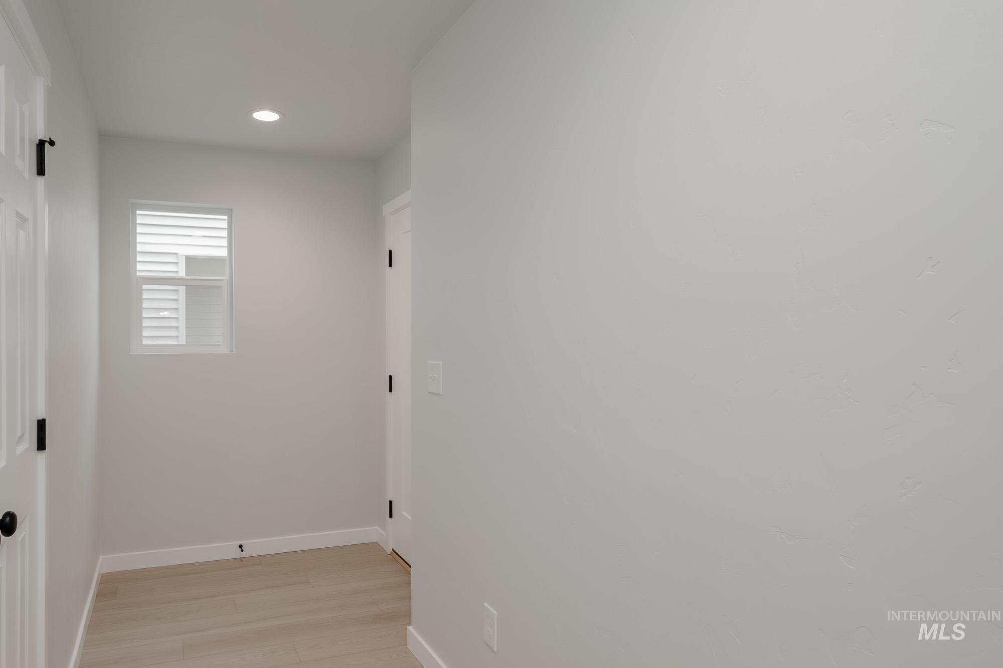 Hallway with recessed lighting and light wood-style floors