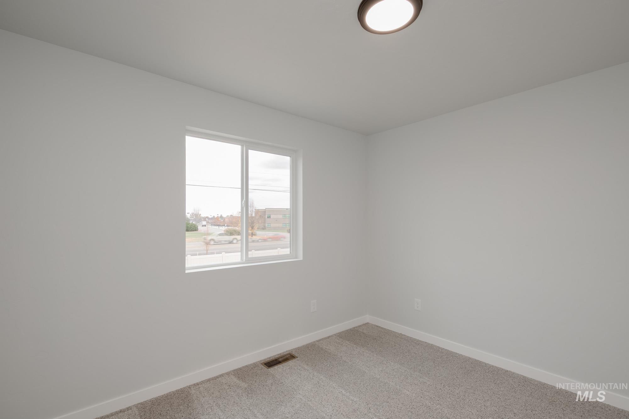 Spare room with carpet flooring and baseboards